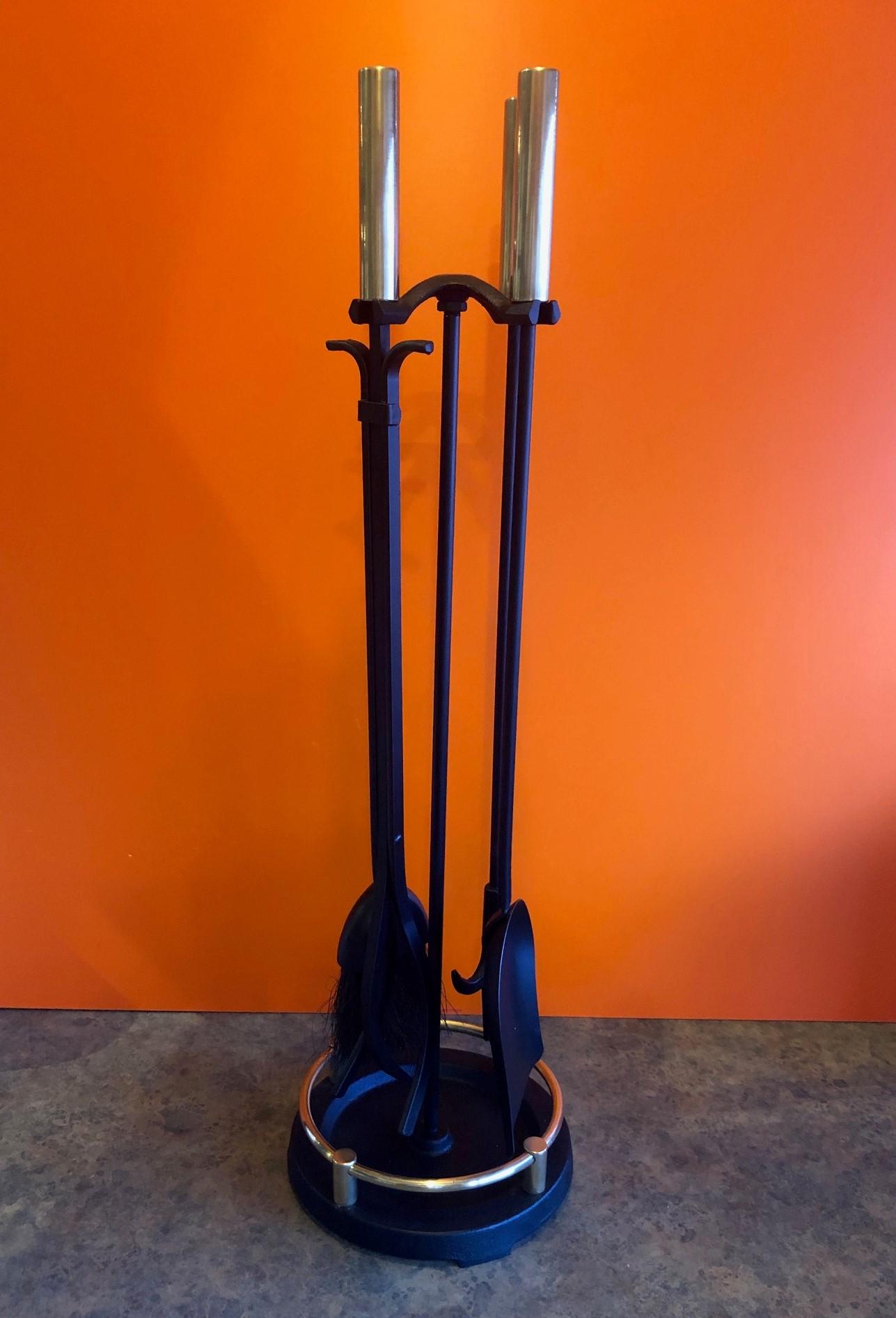 Midcentury American modern set of fireplace tools by Pilgrim, circa 1960s. The set has been professionally polished and refinished and looks fantastic! There are four tools with polished brass cylindrical handles supported by an integral