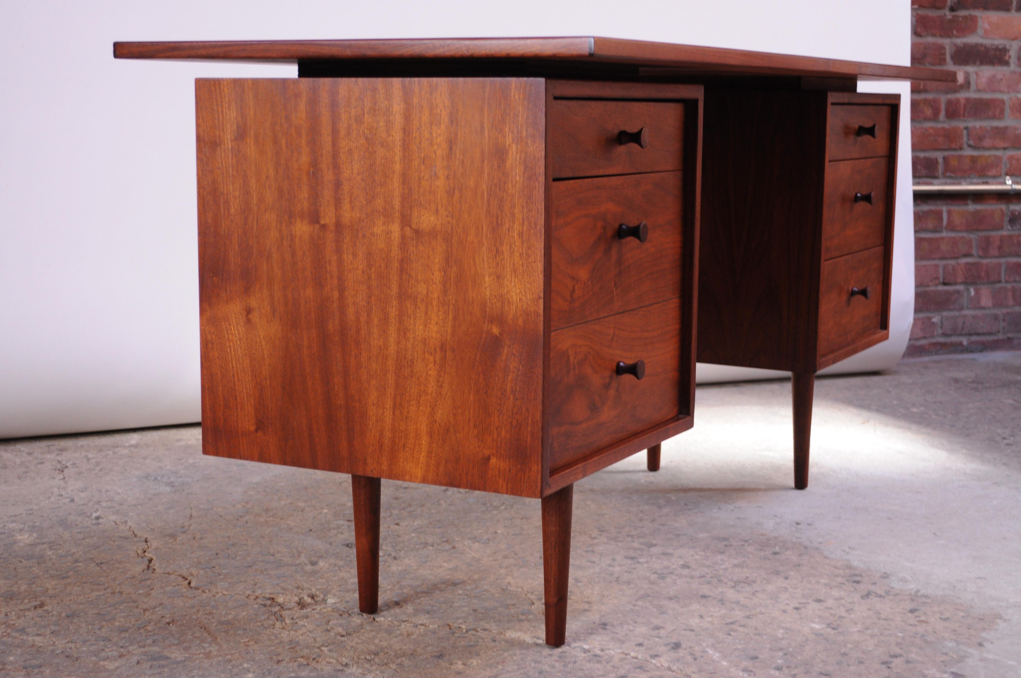 Walnut desk by renowned painter and sculptor, Richard Artschwager, who in 1953 designed a small collection of furniture in New York City. These pieces are scarce, as production and scope of design were exceedingly limited. 
This desk is composed of