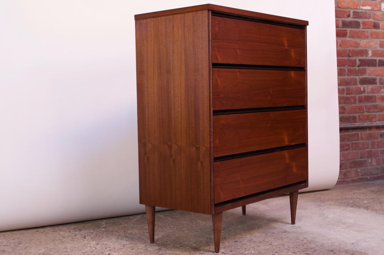Walnut 4-drawer chest designed in the 1950s by Mel Smilow for Smilow-Thielle. Walnut drawers are outlined by ebonized borders (the 'frames' of only the drawers themselves are ebonized, which better reveals the exquisite grain and color of the walnut