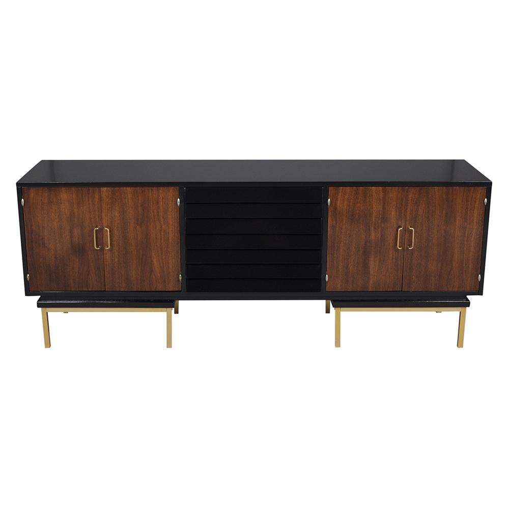 An extraordinary mid-century American of Martinsville credenza that has been professionally restored, is crafted out of wood and comes with a newly stained provincial & ebonized color combination with a lacquered finish. This piece features four