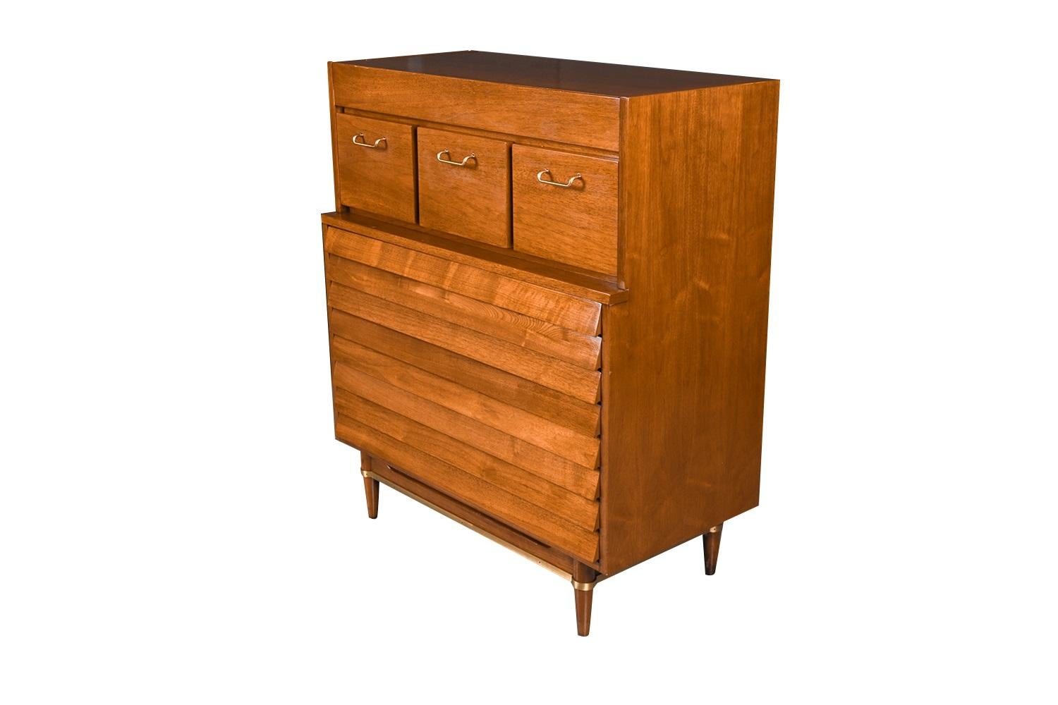 This exceedingly well-crafted American of Martinsville louvered slat front drawer highboy tall dresser was designed by Merton Gershun for his Dania collection. Features the mid-century style and construction quality that keep these pieces in such