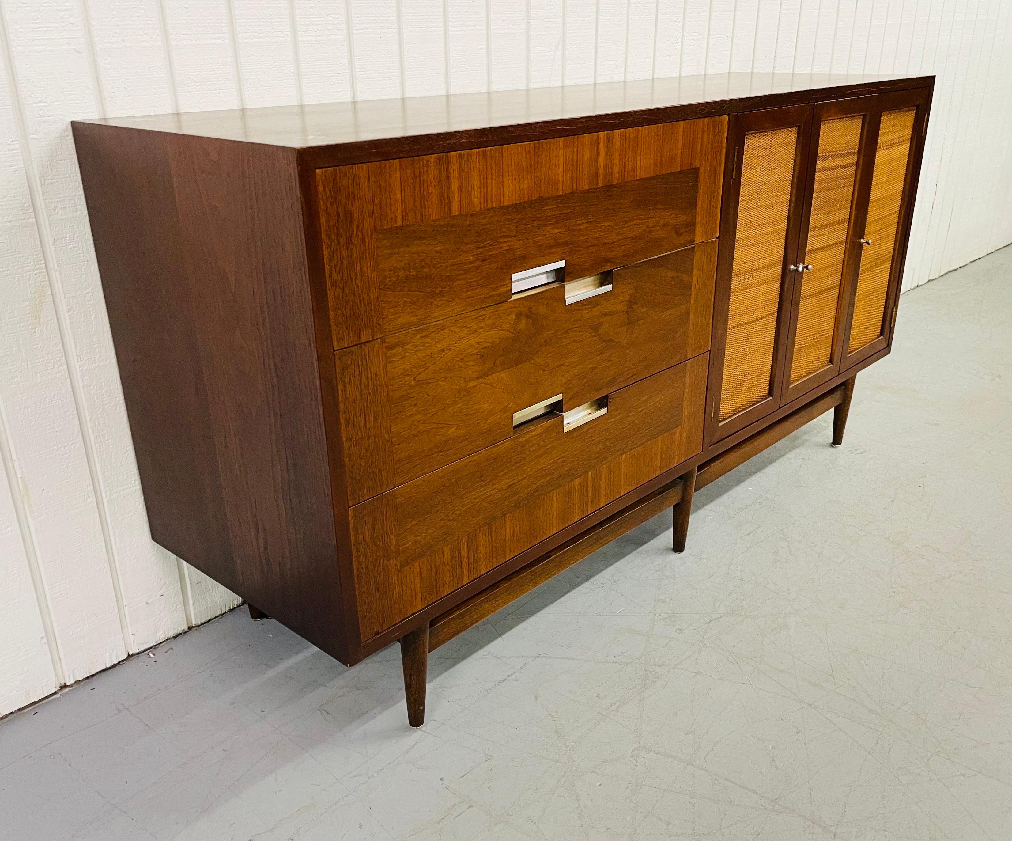 This listing is for a Mid-Century American of Martinsville walnut dresser. Featuring six drawers for storage, cane front doors, and a beautiful inlaid walnut top.