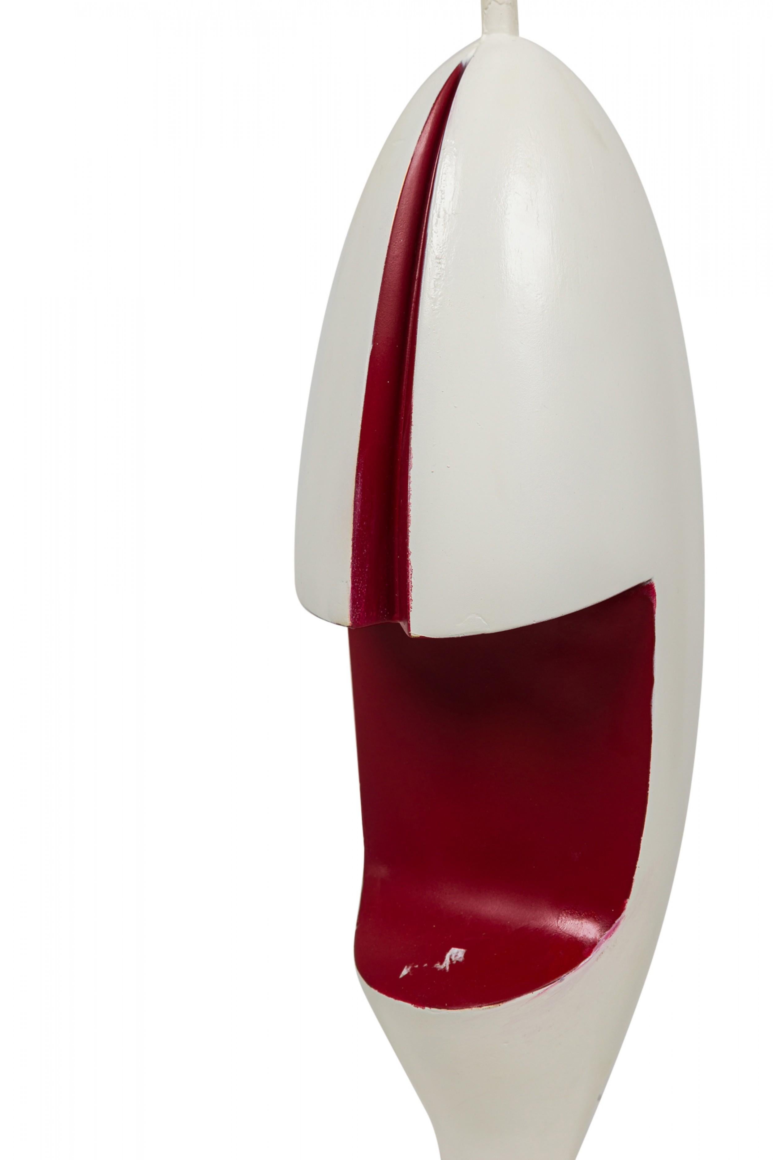 Mid-Century American Harlequin Bishop table lamp composed of red and white painted plaster, sculpted in the form of a bishop chess piece featuring an elongated oval body which splits in half vertically at the upper section with a protruding stem and