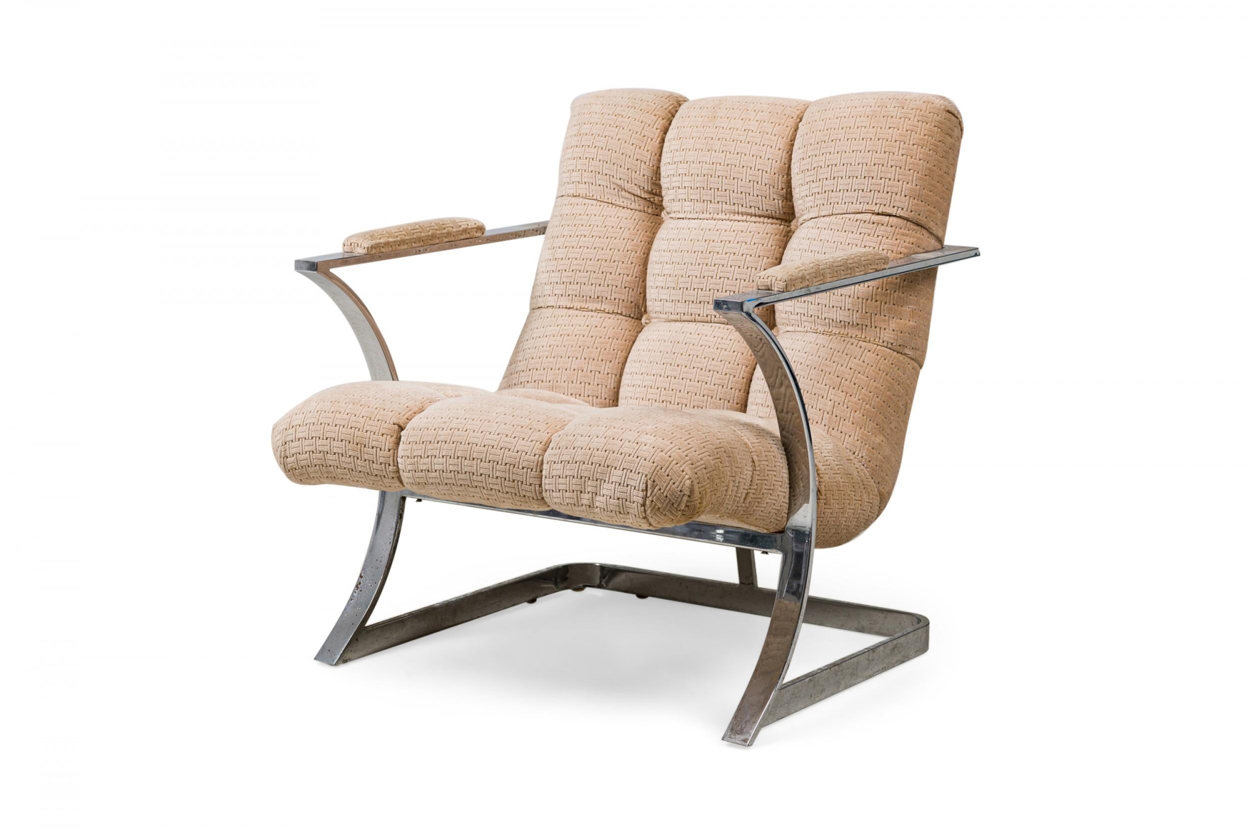 Midcentury American polished silver metal flat bar armchair with a curved concave frame, the arms unified with the back as one piece, upholstered in a button tufted textured beige fabric. (manner of MILO BAUGHMAN)