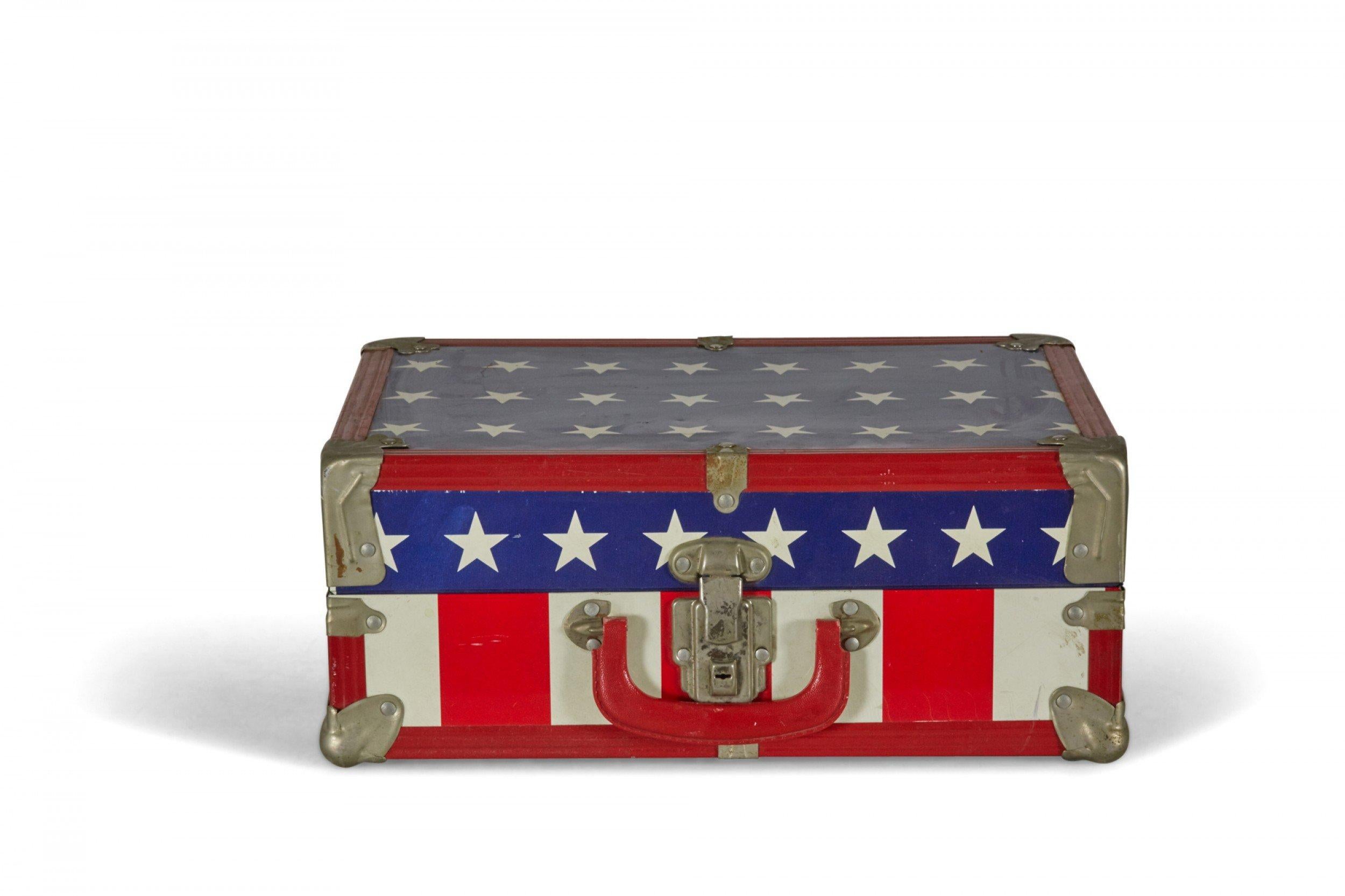 American Mid-Century child-sized suitcase with an American flag motif, silver metal corners and latch, and a newspapered interior.