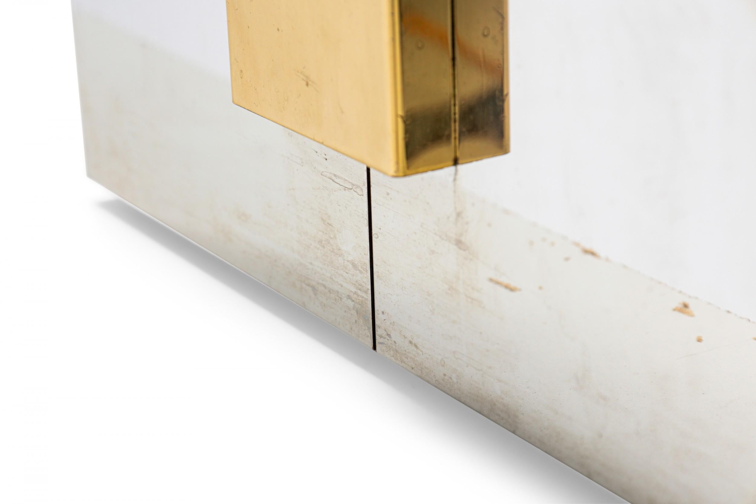 Mid-Century American square pedestal with stainless steel sides and a polished brass rectangular wall intersecting the center at a perpendicular angle.

Minor separation of metal veneer from form.
