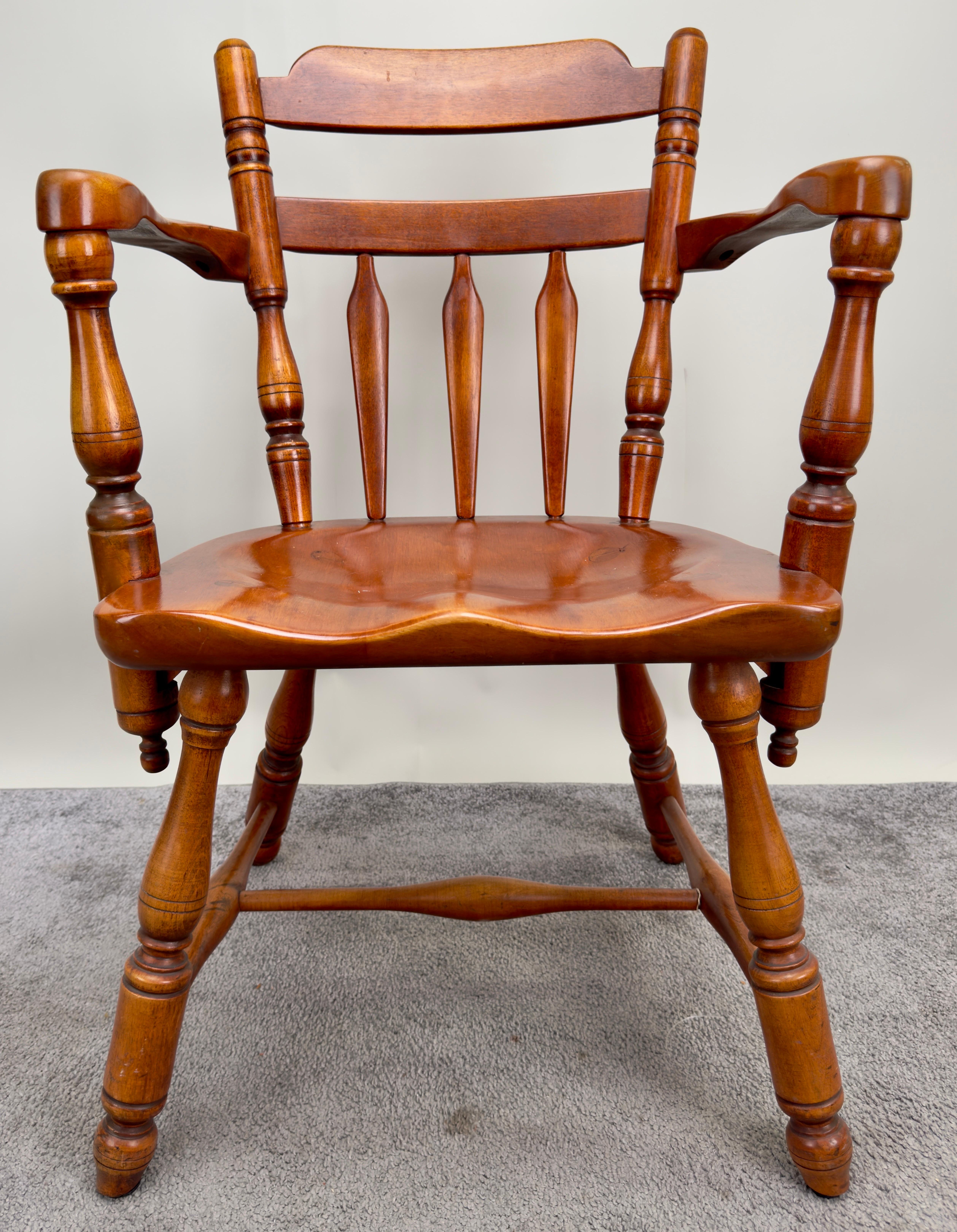 A mid-century Americana armchair, fashioned with pride from premium maple wood. Embodying the essence of Americana colonial design, this chair is a testament to exquisite craftsmanship and attention to detail.
 The arms, set at almost 90-degree