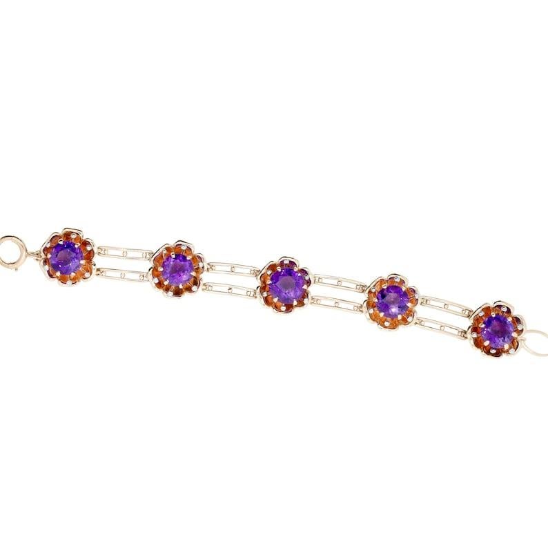 Aston Estate Jewelry Presents:

A beautiful Buttercup floral motif bracelet centered by rich vivid purple Amethysts. Featuring five buttercup flowers centered by amethysts, and accented with platinum tipped stamen. Of 16 carats total weight, the