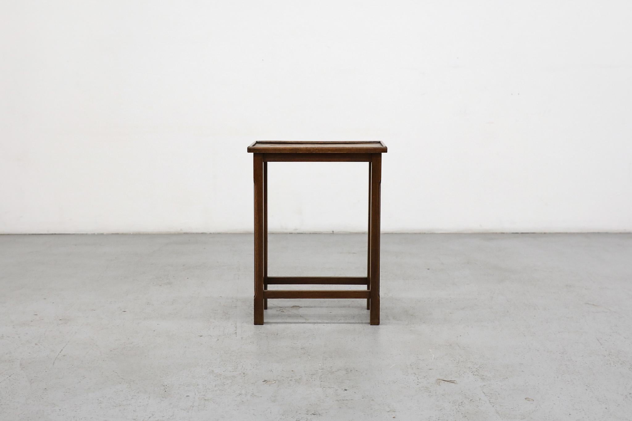 Amsterdam School - Art Deco oak side table. Small, traditionally styled as a side table with decoratively carved legs and attractive oak grain. Lightly refinished with some visible wear that highlights its original condition. Top has rippling and