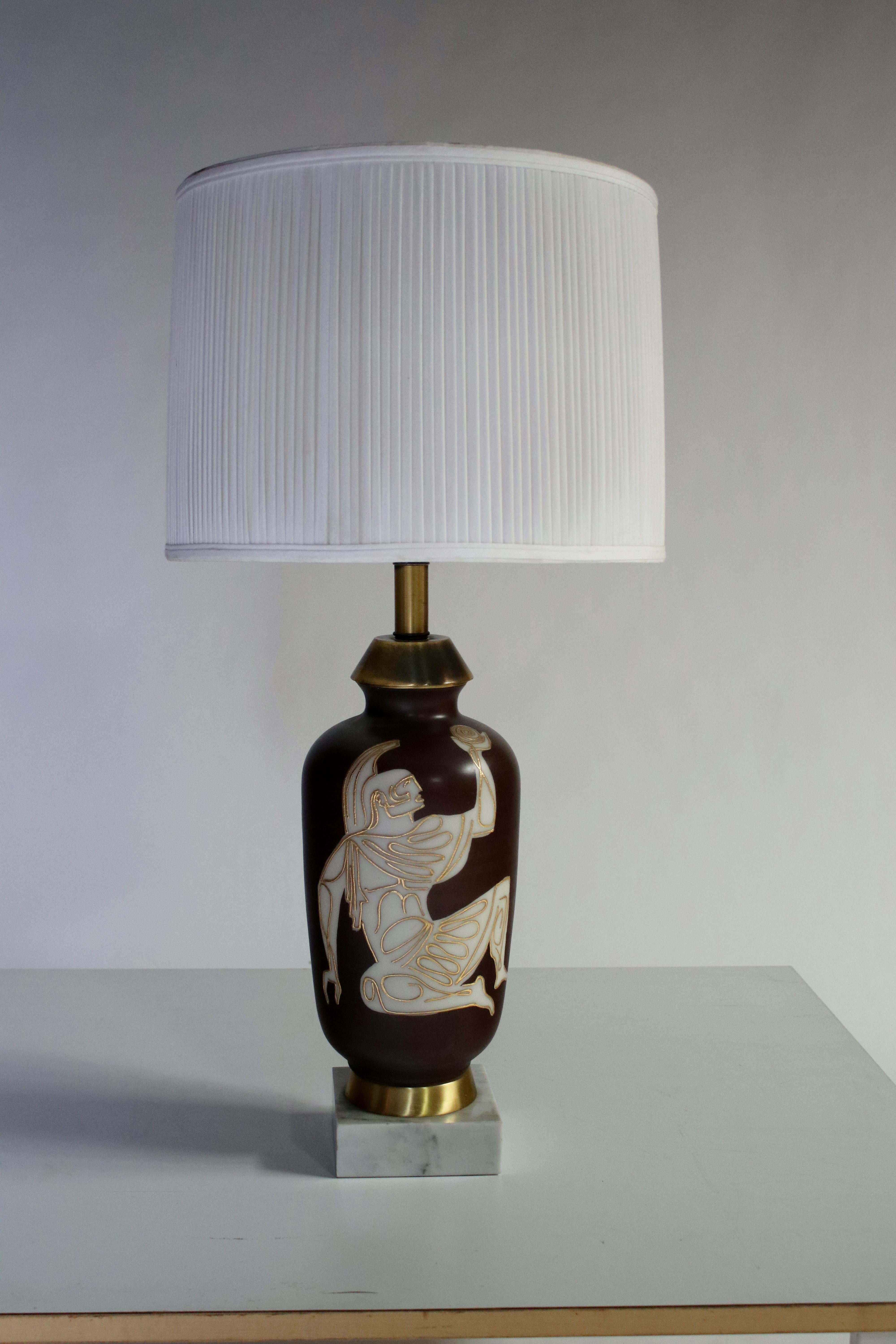 Unique mid-century table lamp depicting a Roman gladiator motif with ancient symbols on a brown glazed urn. Lamp is mounted on a thick marble plinth with brushed brass accents. Shade not included.
