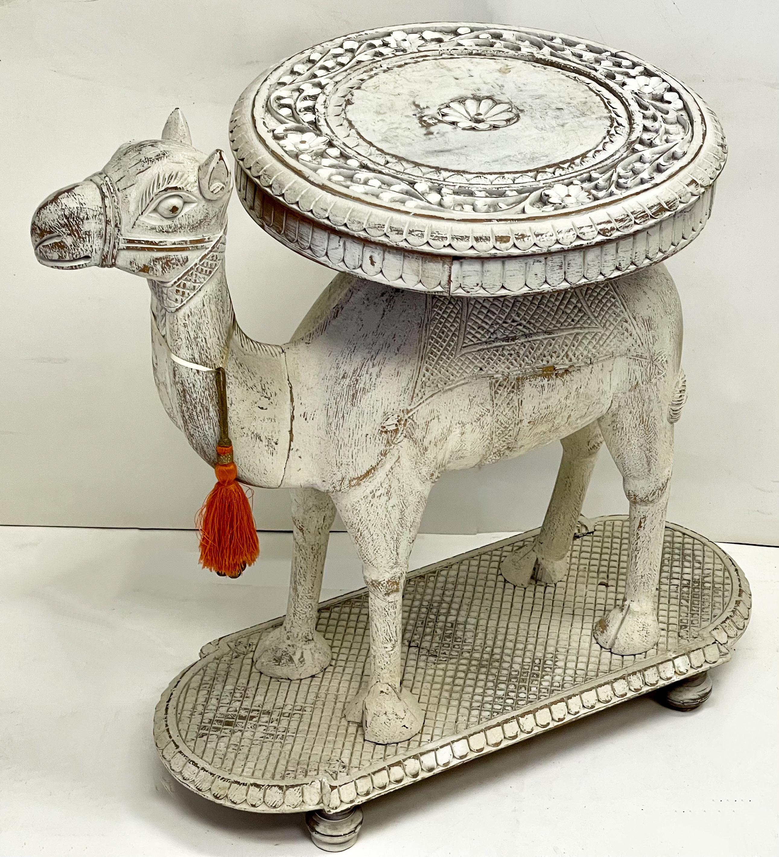 This is a mid-century Anglo- Indian carved white washed camel form side table. He is most likely made of teak, but the vintage white washed finish does make proper wood identification challenging.