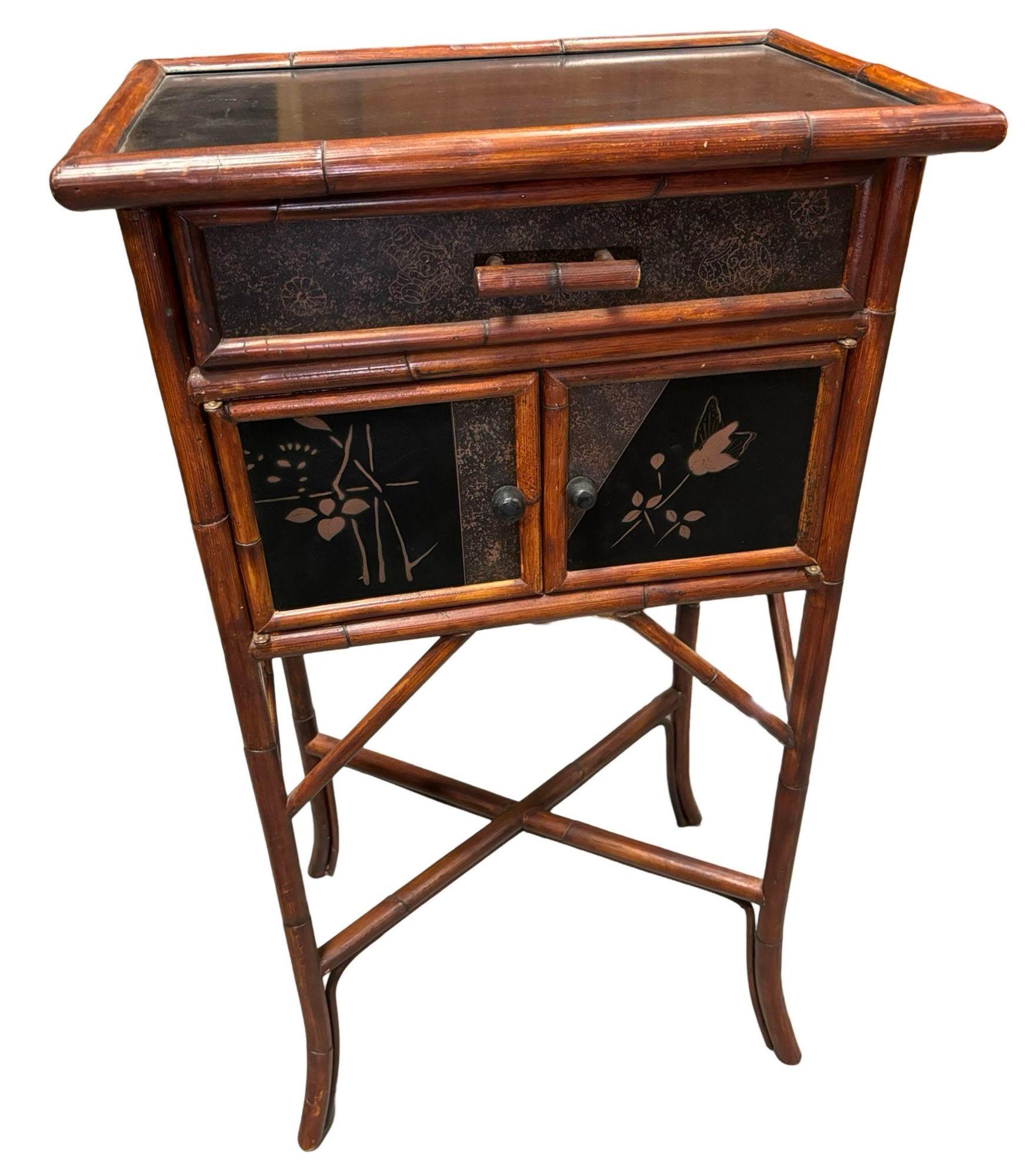 This Mid-Century Anglo-Japanese Style Bamboo Framed Side Cabinet, circa 1940s, combines the elegance of Japanese design with Western craftsmanship. The sturdy bamboo frame is enhanced by a rich black lacquer finish, beautifully showcasing intricate