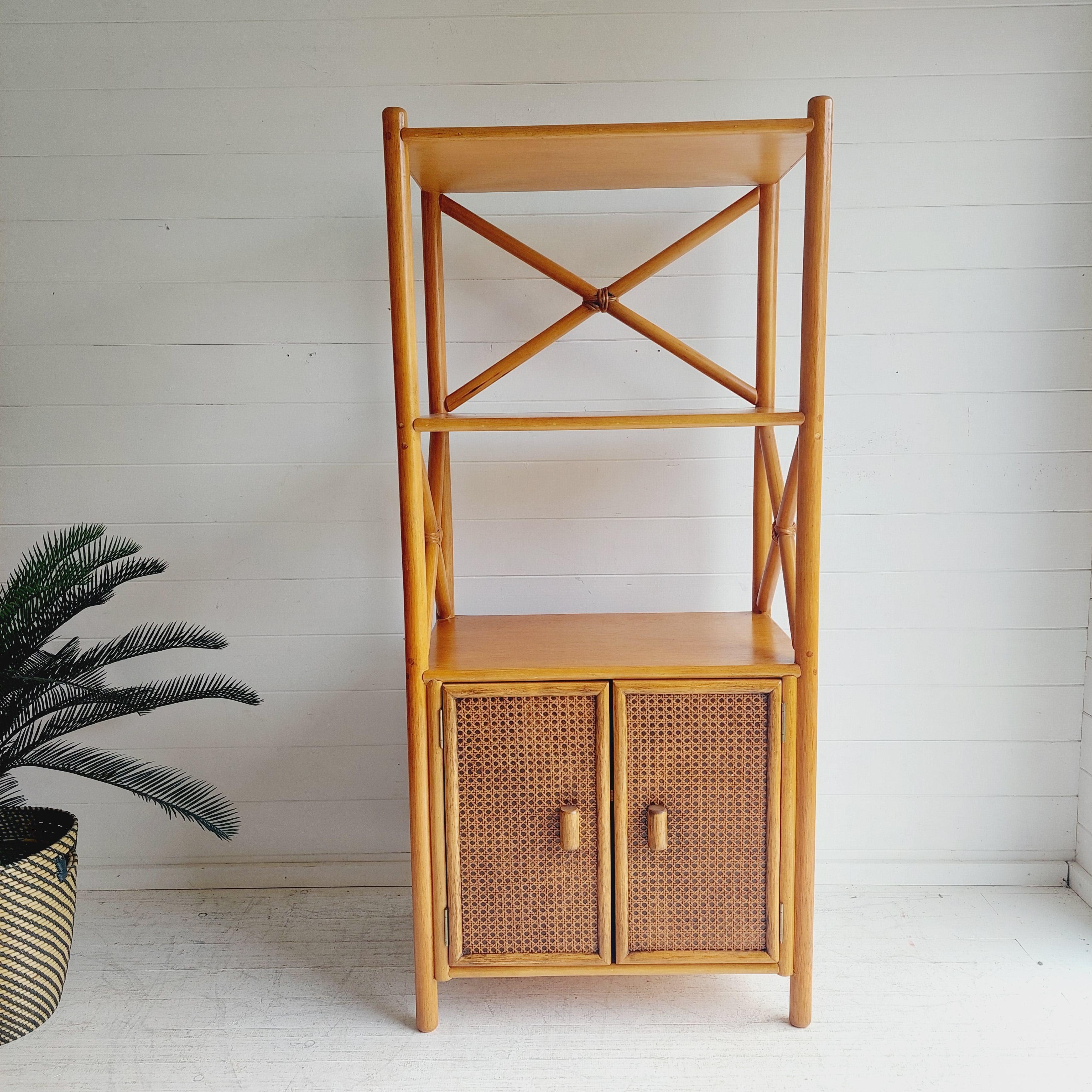 A beautifully designed & crafted, tall storage shelving Unit.
Manufactured by Angraves.
Circa 1970/80s
Made in Uk
Made of Bamboo, rattan and cane.

The unit includes a good sized cupboard to the lower section with internal adjustable shelf. 
3 fixed