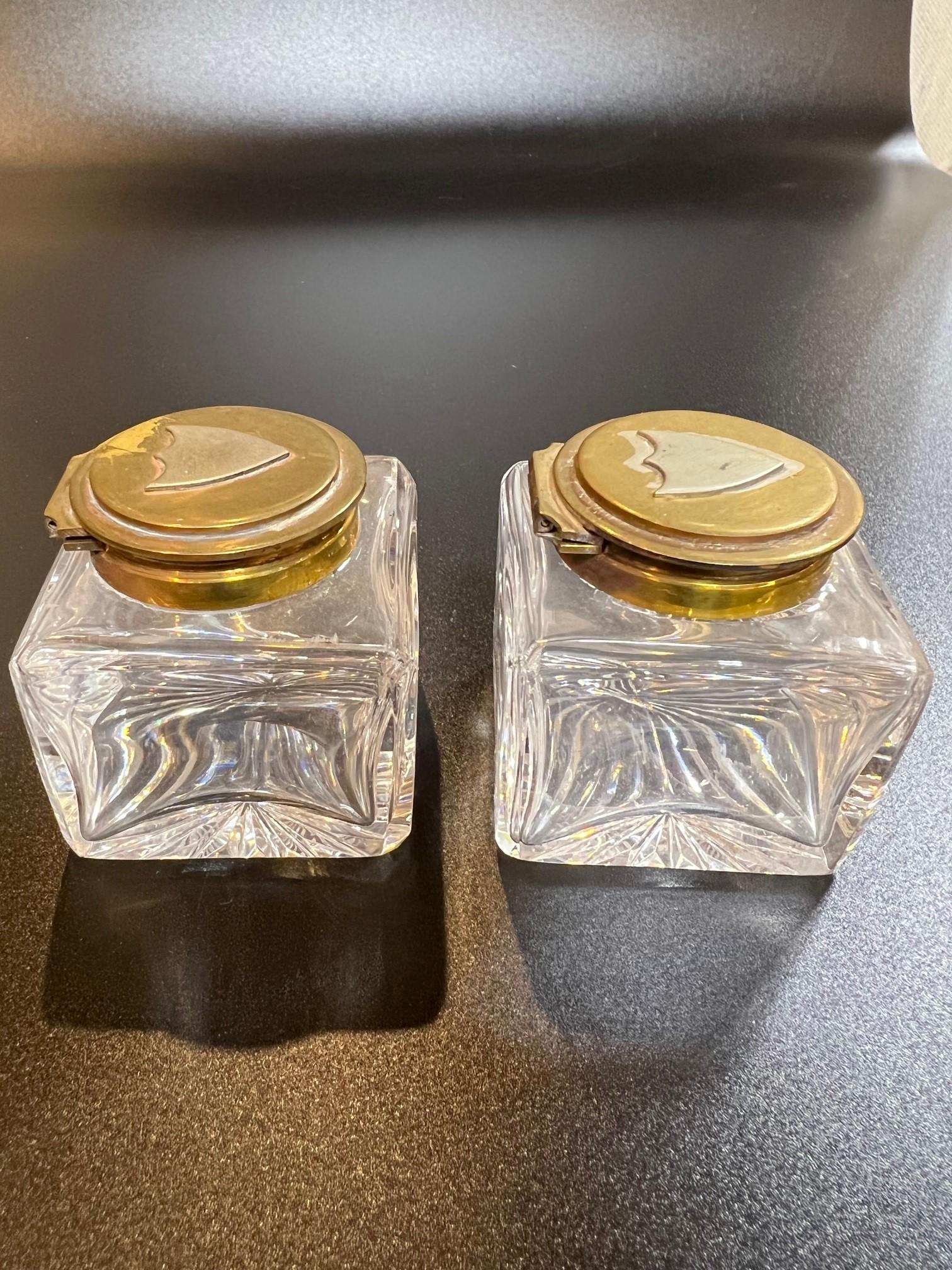 English Mid-Century Antique Pair of Glass Inkwells with a Brass Lid and a Shield on Top For Sale