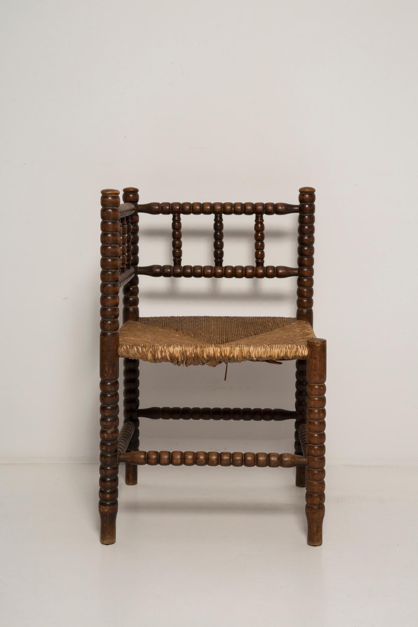 A fine French Provincial corner chair in stained oak with a handmade cane seat. Classic bobbin turned legs and in a overall fine vintage condition. Made in the 19th century.  Lovely handmade chair that will complement many interior styles. A modern,