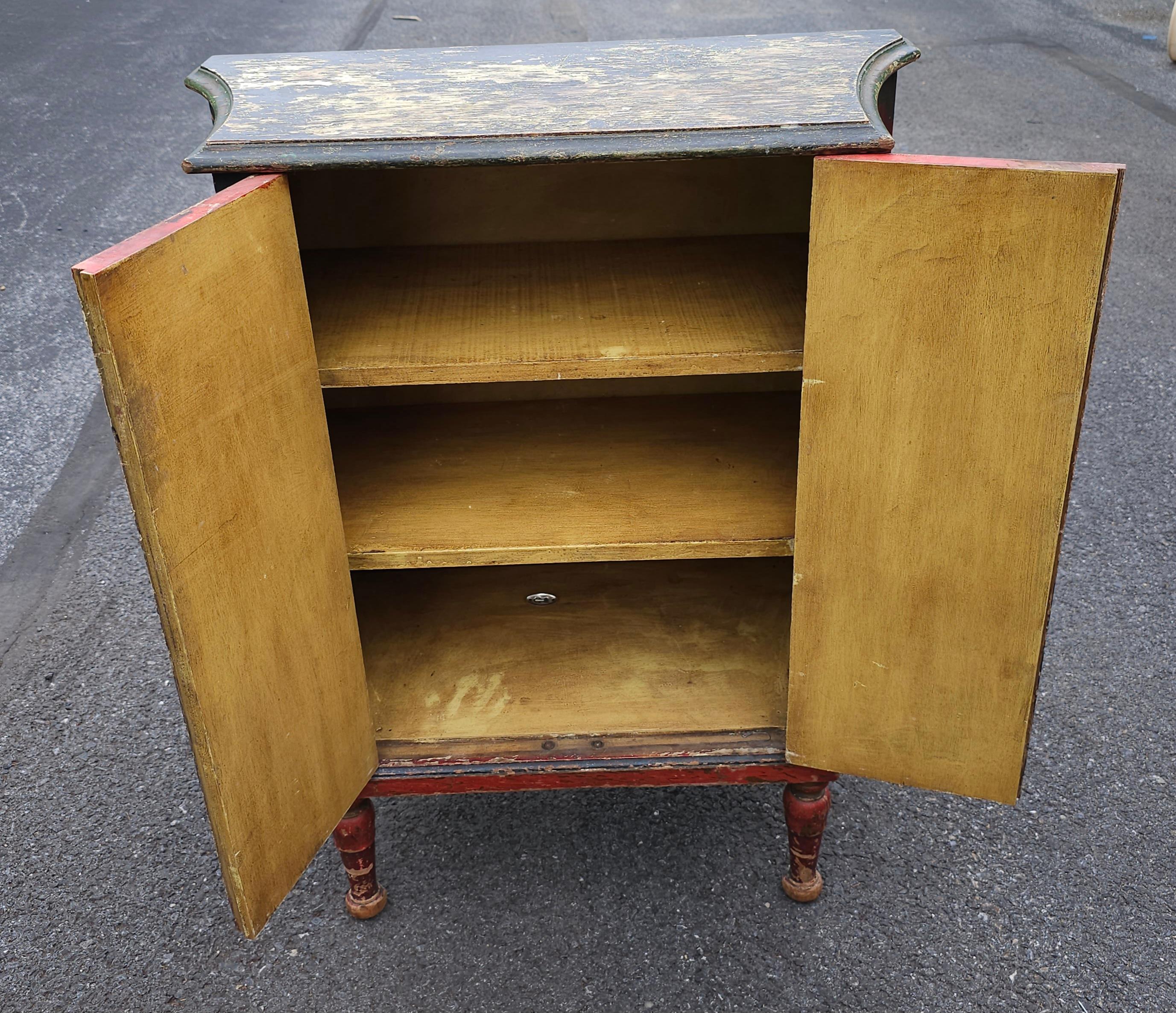 A Mid-Century Antiqued Painted and Decorated Two-Door Side Cabinet. Comes with two adjustable height shelves.
Measures 27.75