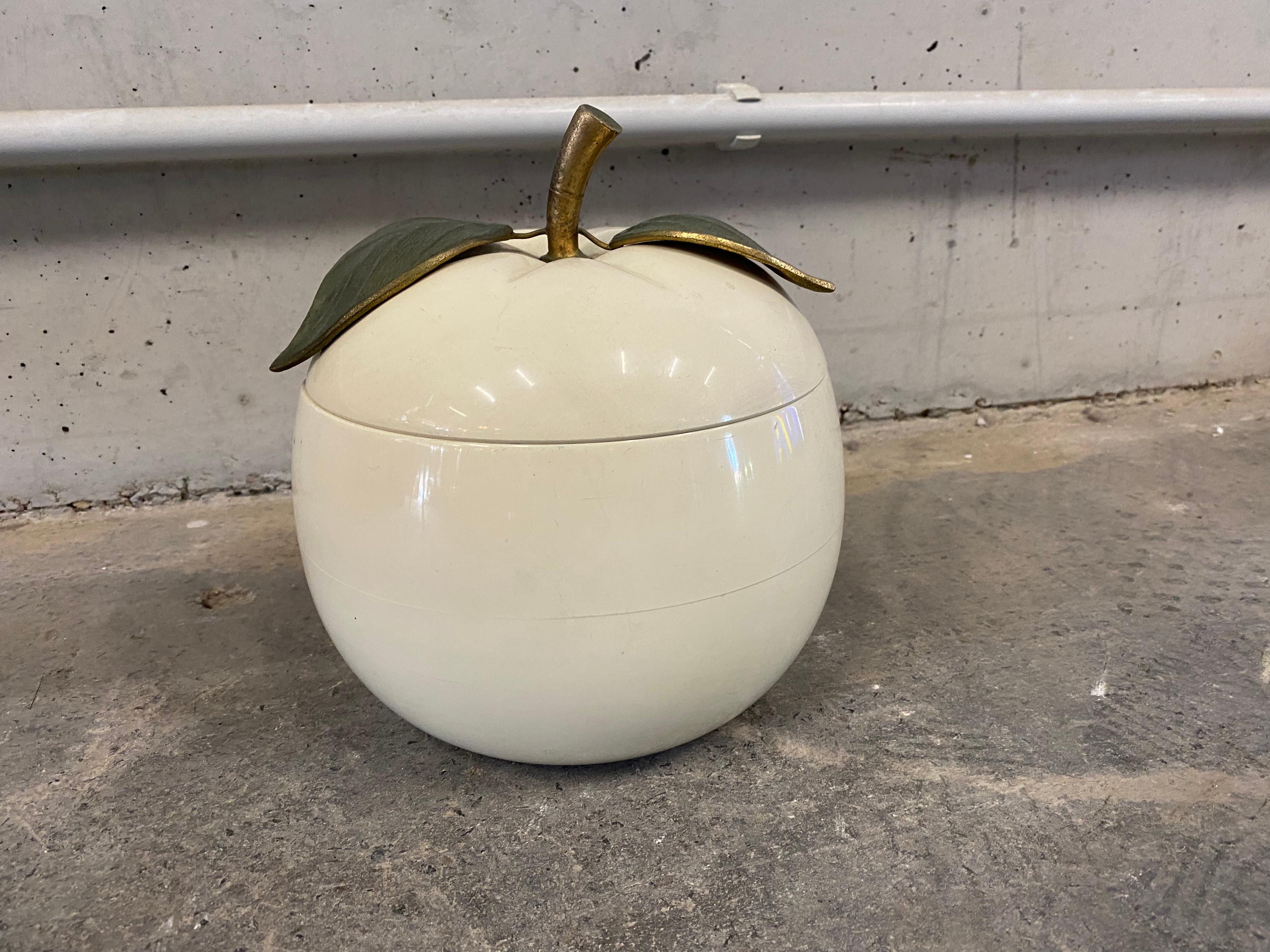 Beautiful creamy white apple ice bucket with gold leaf and stem by Swiss company Freddo Therm from the 1970s. This detailed ice bucket in the shape of an apple is a beautiful, luxurious addition to the home bar or just a special decoration for the