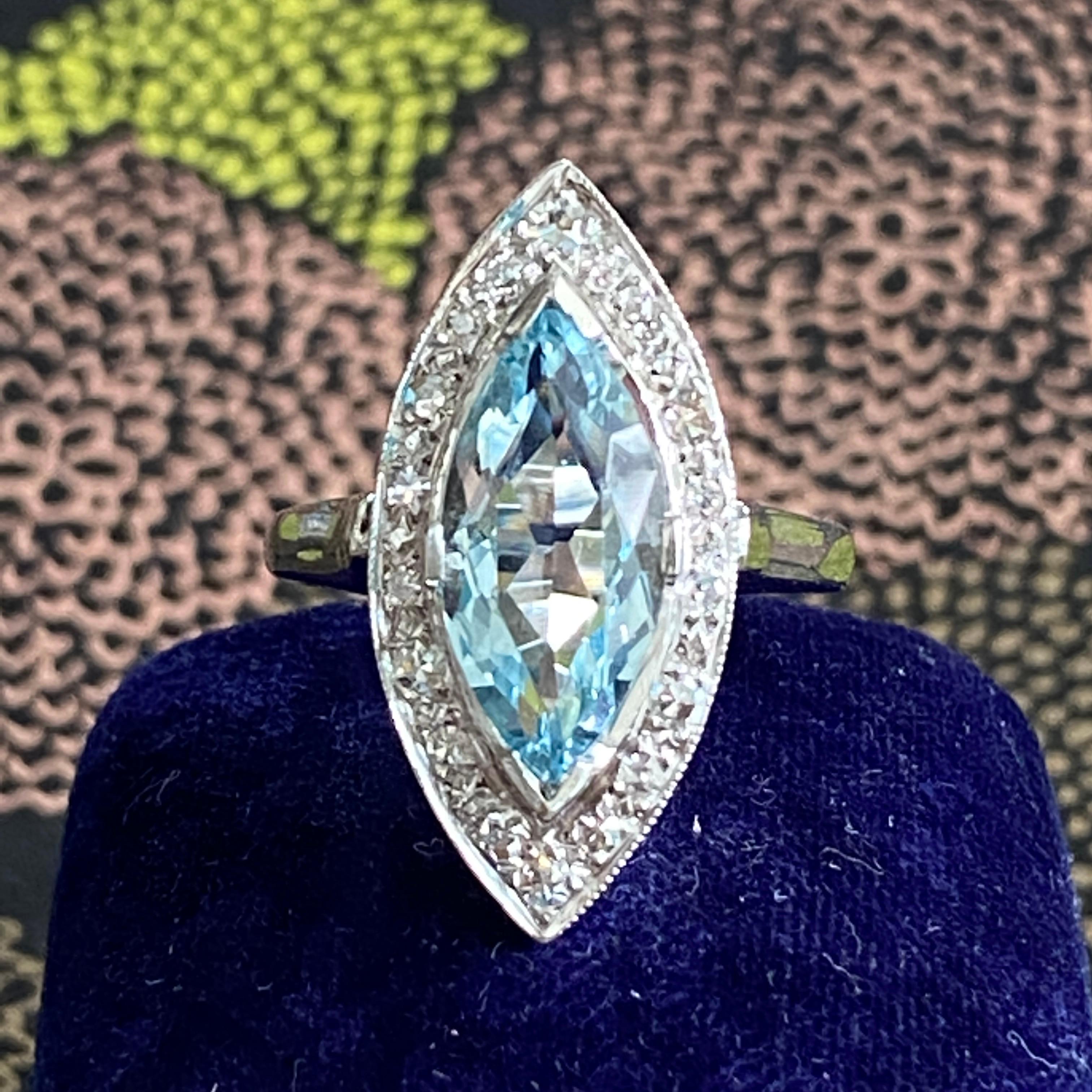 Details:
Classic Vintage marquise aquamarine and diamond ring! The marquise cut aquamarine measure 15.6mm x 7.6mm (approx 2.5 carats); and the 19 diamonds measure 1.75 to 2.25mm. The aquamarine has a light, classic beautiful blue color. The front of