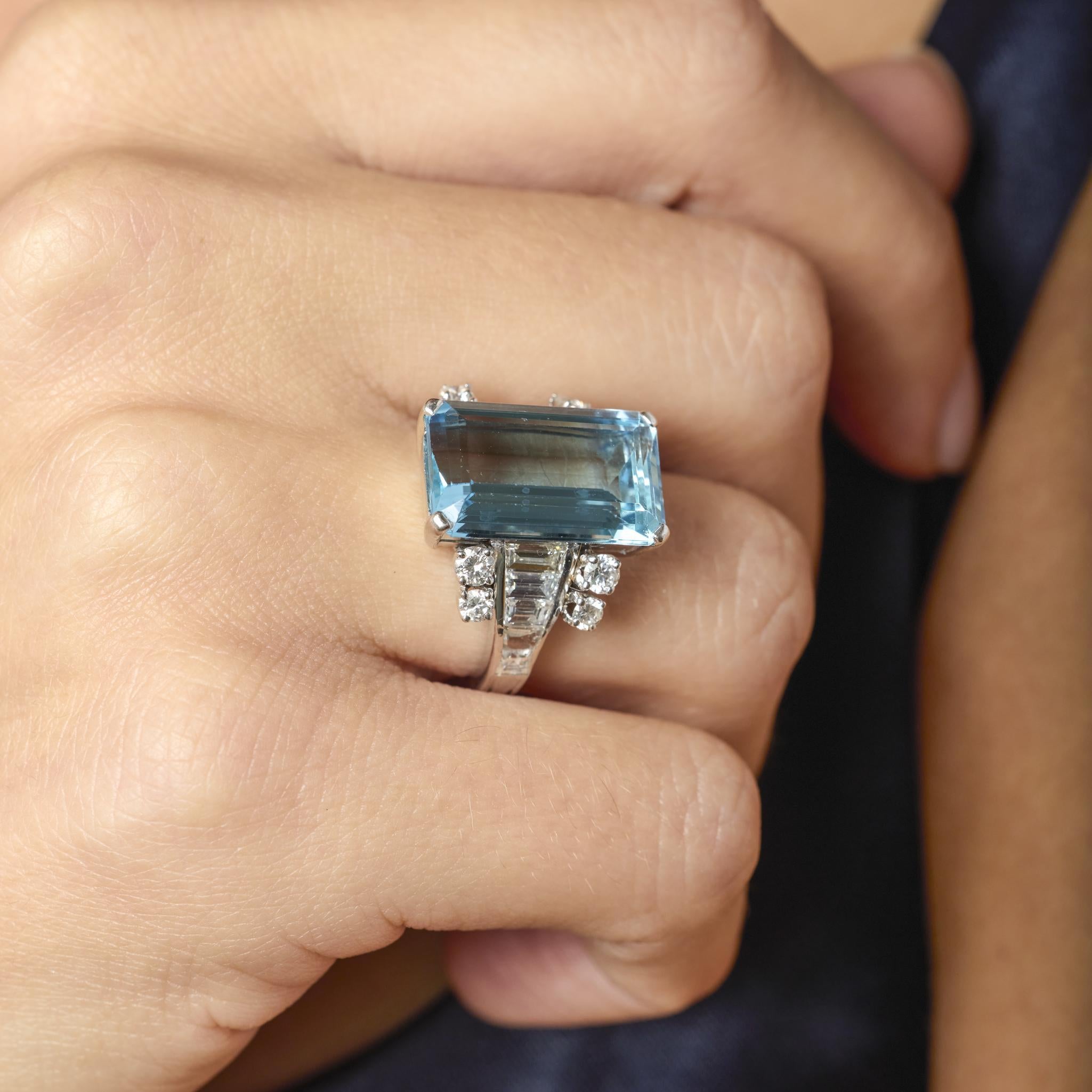 This Mid Century ring showcases an 8.30 carat aquamarine framed by sparkling F-G color diamonds, crafted in platinum for timeless elegance.