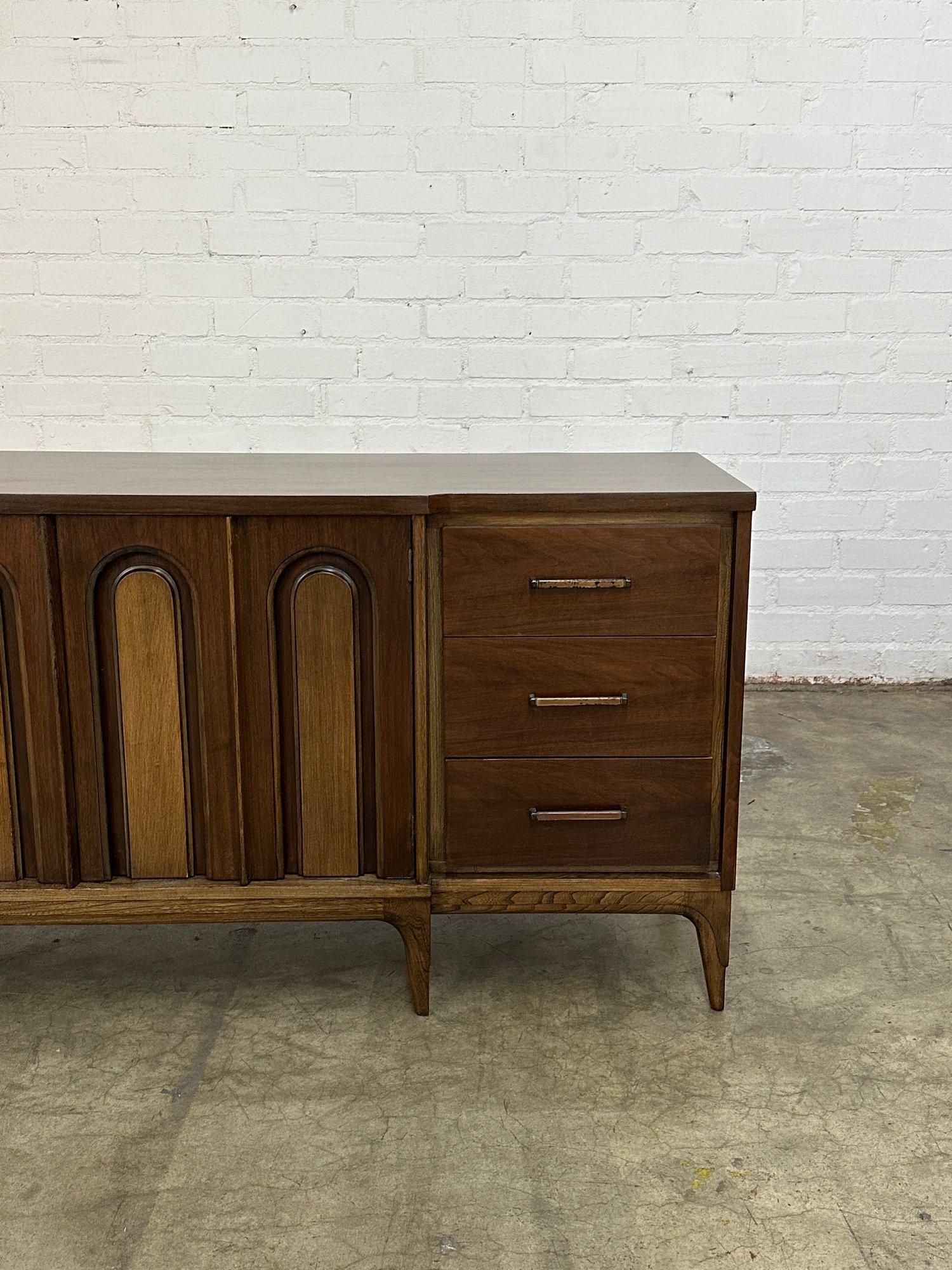 W76.5 D20.5 H31

Vintage Large Credenza in fully restored condition. Item features ample storage with double doors revealing more drawers. Credenza also features sculpted legs, arched details that serve as handles, and original hardware with patina.