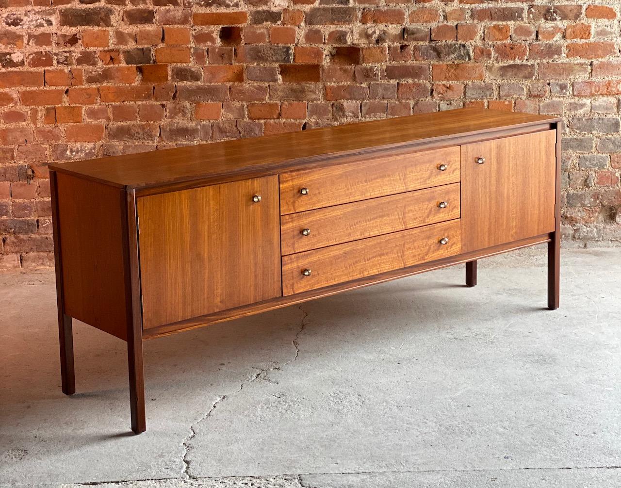 Midcentury Archie Shine Afromosia teak sideboard, circa 1961

Stunning Mid-Century Modern Archie Shine Afromosia Teak sideboard circa 1961, the sideboard with its Afromosia teak finish has two cupboards either side of four central pullout /