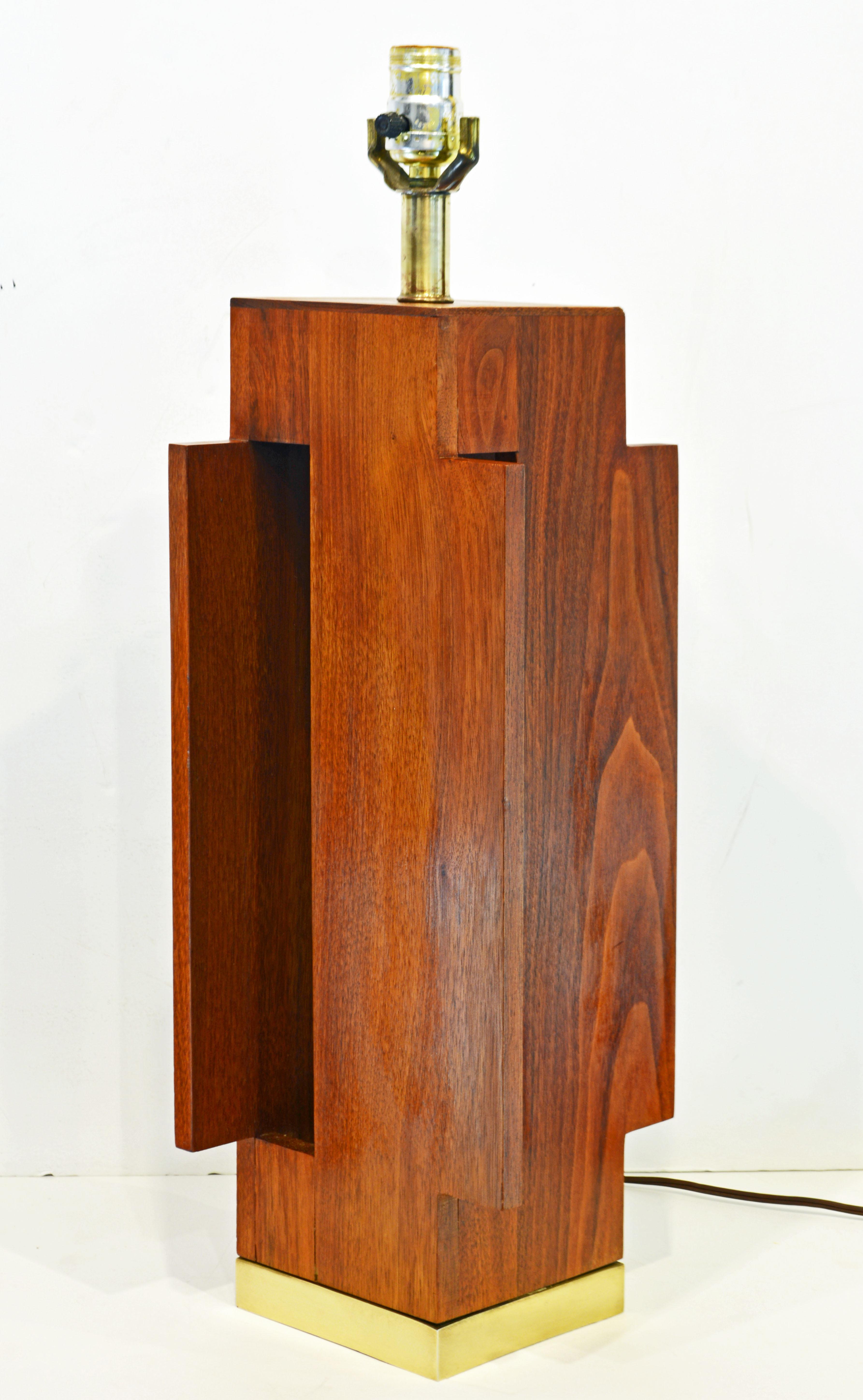 This mid-century artistic teak table lamp offers new inspiring views from all angles like a beautiful modern building. It is mounted on a cast solid brass base.