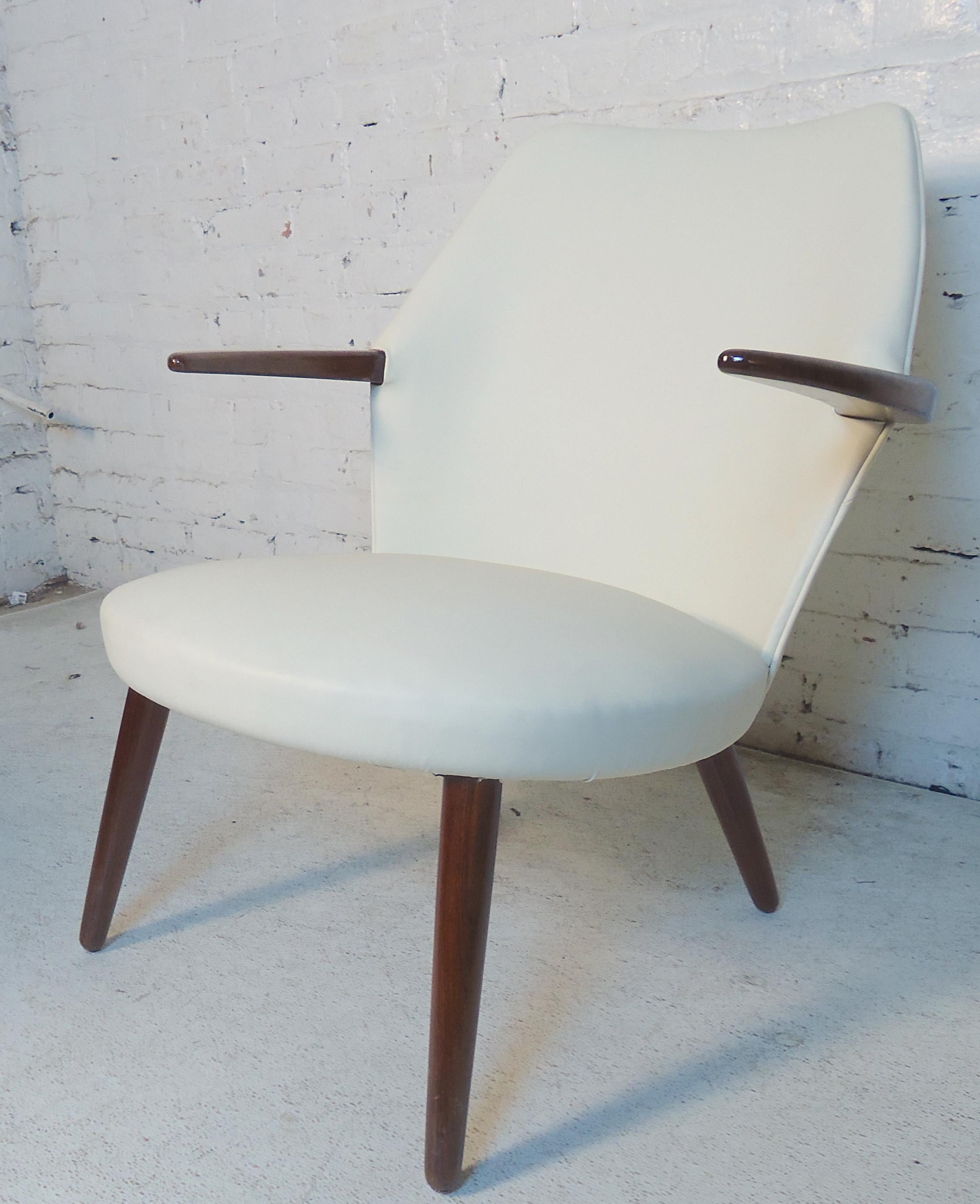 Unusual vintage modern armchair with white Naugahyde and rosewood arms and legs.
(Please confirm item location - NY or NJ - with dealer).
 