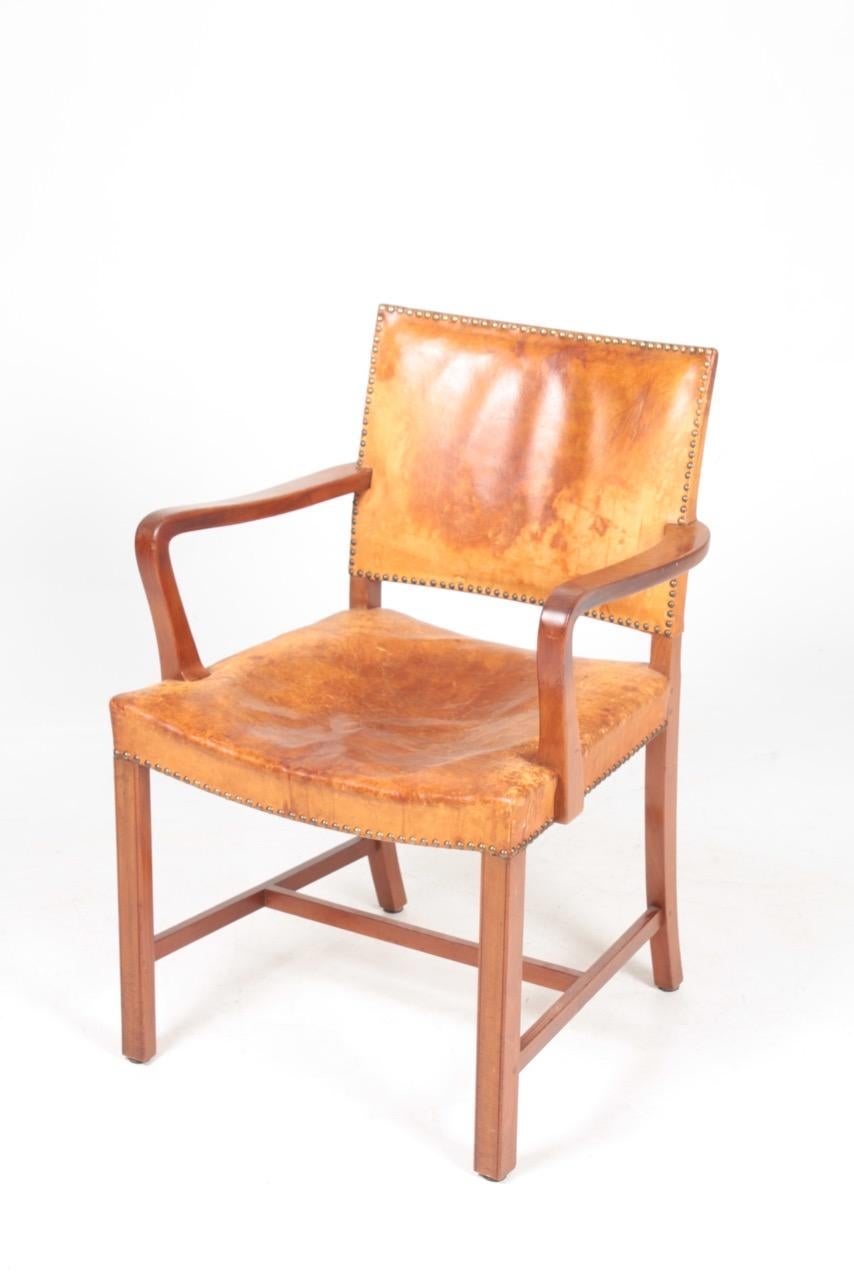 Danish armchair in patinated Niger leather and mahogany. Designed and made in Denmark, great original condition.