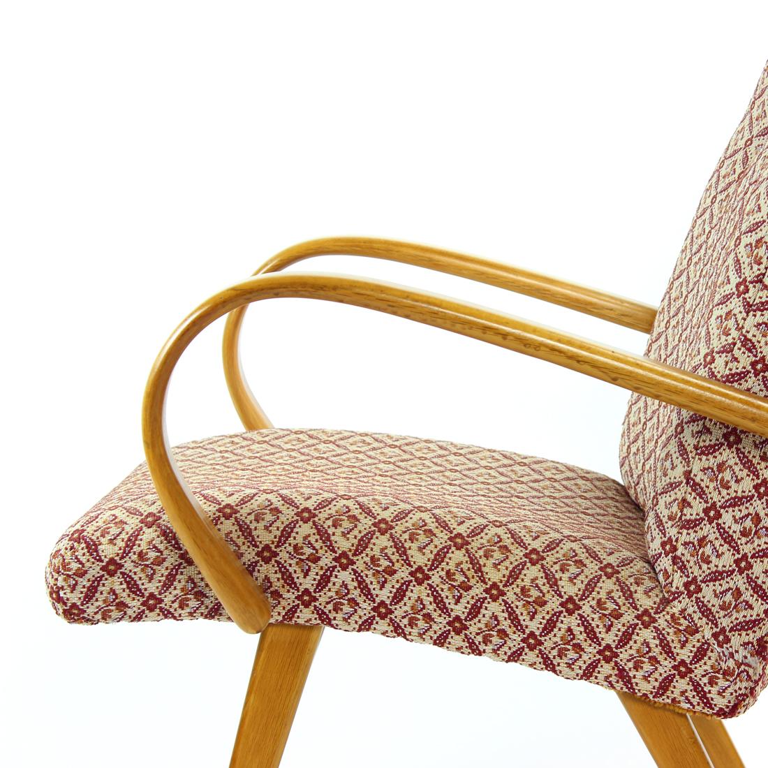 Beautiful Mid-century armchair with typical design for the era. Produced in Czechoslovakia by TON, original label still attached. The chair is partially restored with newly restored wooden parts. The chair shows beautiful design with smooth, bent