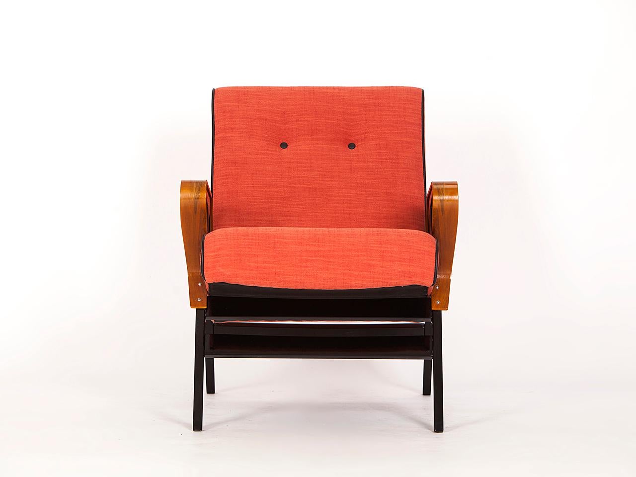 This lounge chair was produced in the 1960s by the Czechoslovak company Tatra Pravenec. This piece has been completely restored with new linen upholstery and newly painted wooden parts. The armrests are made with veneered walnut.