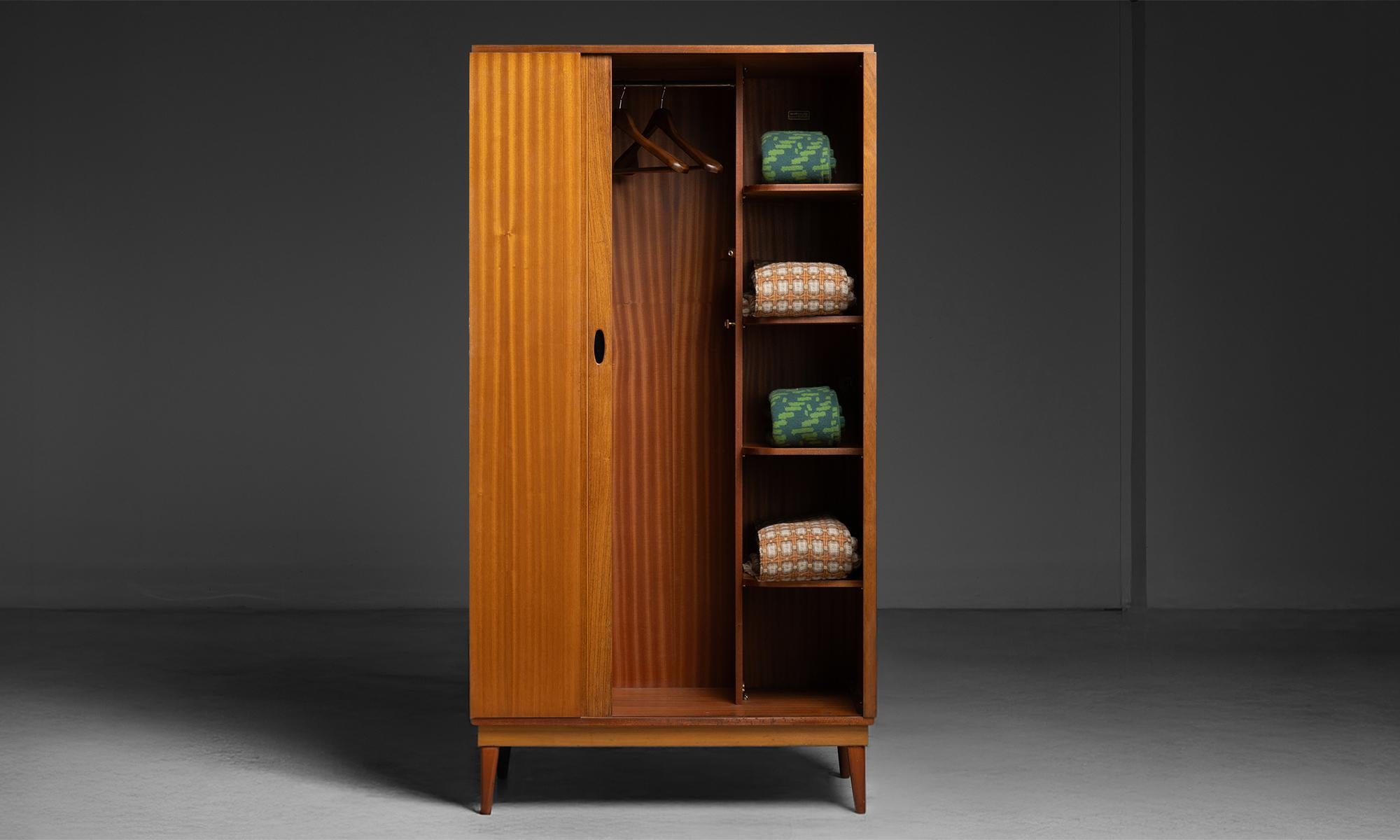 Mid Century Armoire

England, 1960

Teak armoire produced by Austinsuite Furniture during the 1960s. Tambour sliding door with garment storage on one side and shelves on the other.

DM002