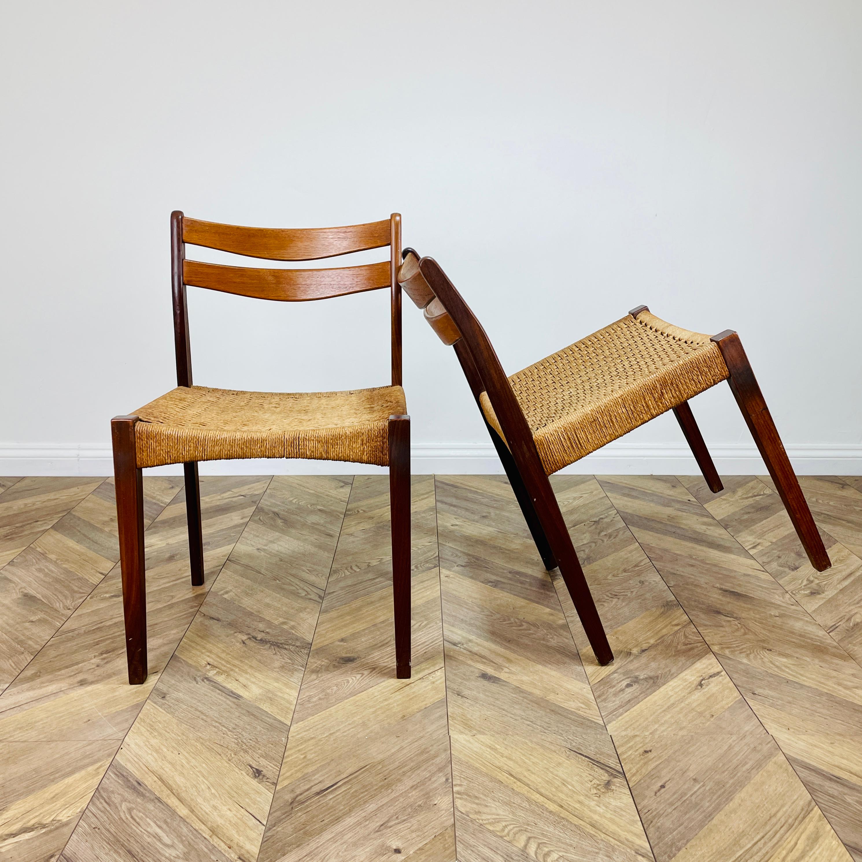 A Pair of Beautiful Dining Chairs, Designed by Arne Hovmand Olsen for Mogens Kold in Denmark. Circa 1960s.

Teak framed with handwoven original paper cord seating. The cord is flexible so shapes to each person. The gently curved backrest offers