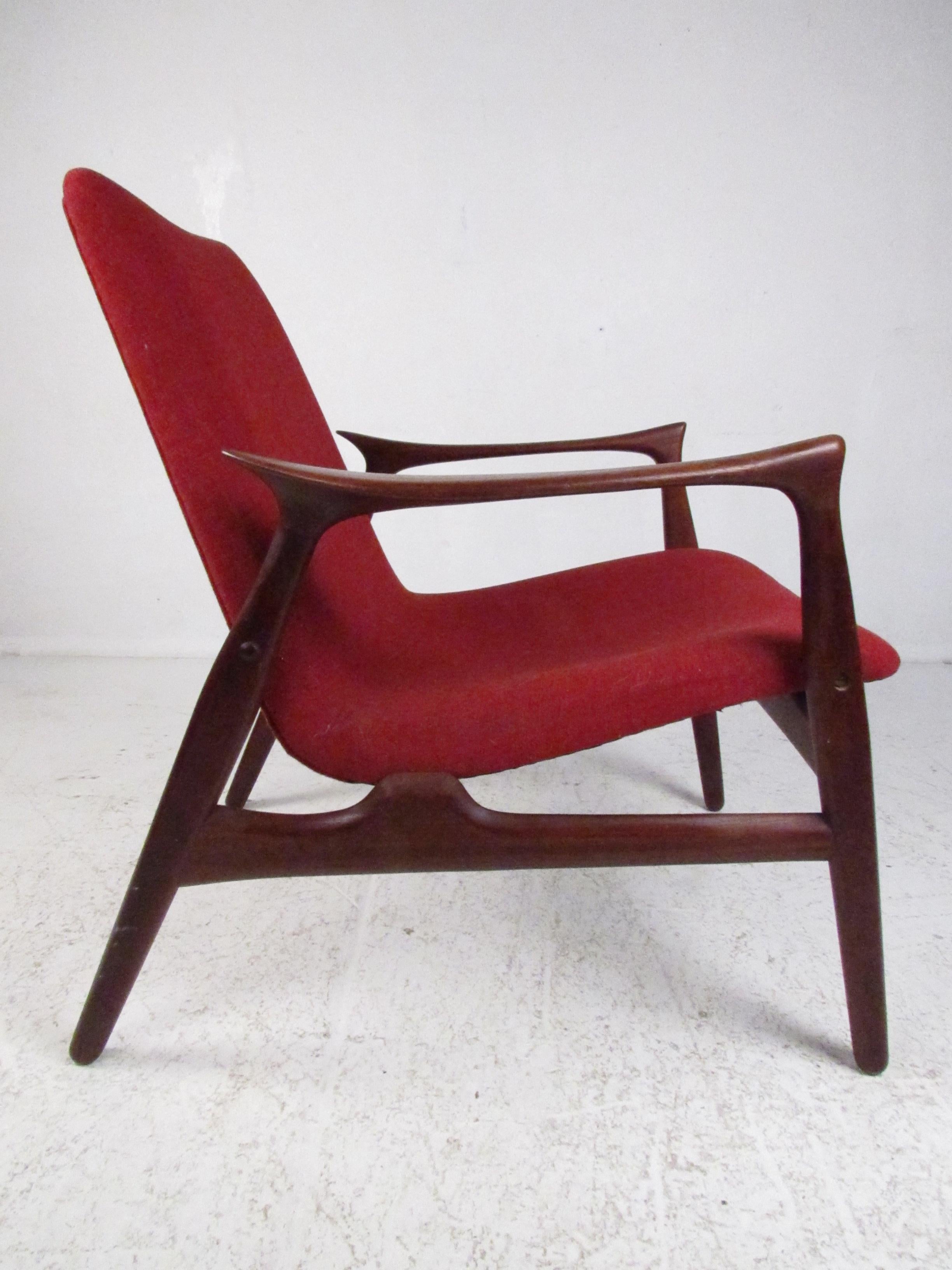 This stunning Danish modern armchair was designed by Arne Hovemand-Olsen for Mogens Kold. A sleek design called, 