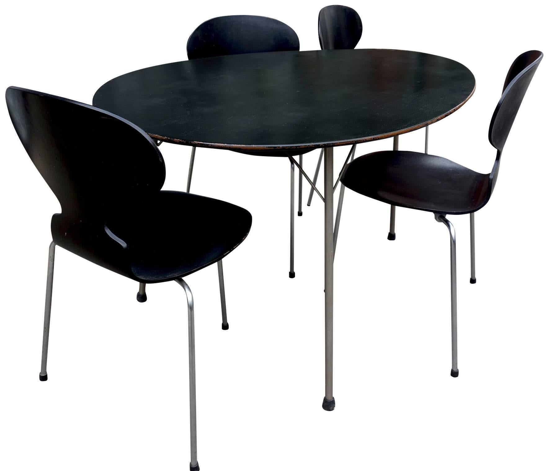For your consideration is this wonderful kitchen table or dining room set. The Egg table is visual genius with such a relatable / recognizable organic form. Perfectly paired with four-three legged Ant chairs. This grouping was originally purchased