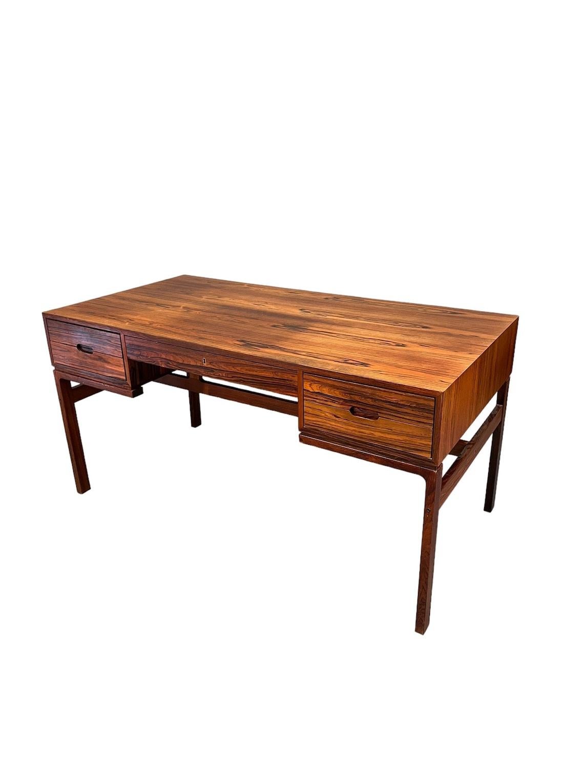Mid-Century Rosewood Arne wahl Iversen writing desk

Dimensions:
56” w x 28” d x 29” inches

This beautiful mid-century desk is made from high quality rosewood and features a stunning natural finish. With its elegant brown color and sleek design,