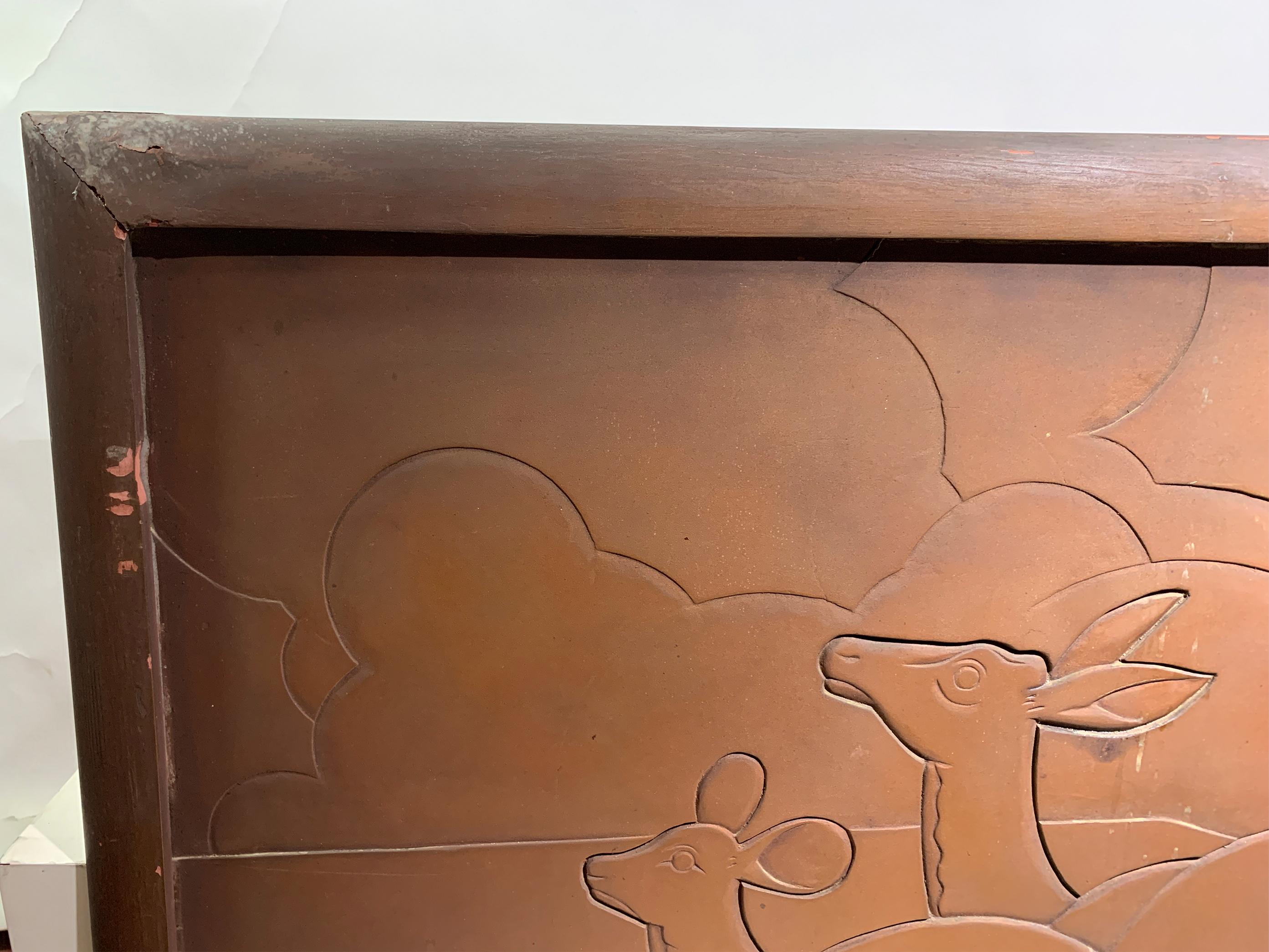 This Art Deco engraved wood panel features an elegantly stylized depiction of two leaping deer against a scenic backdrop of rolling clouds and lush foliage. The intricate design captures the fluid movement and grace of the animals, embodying the