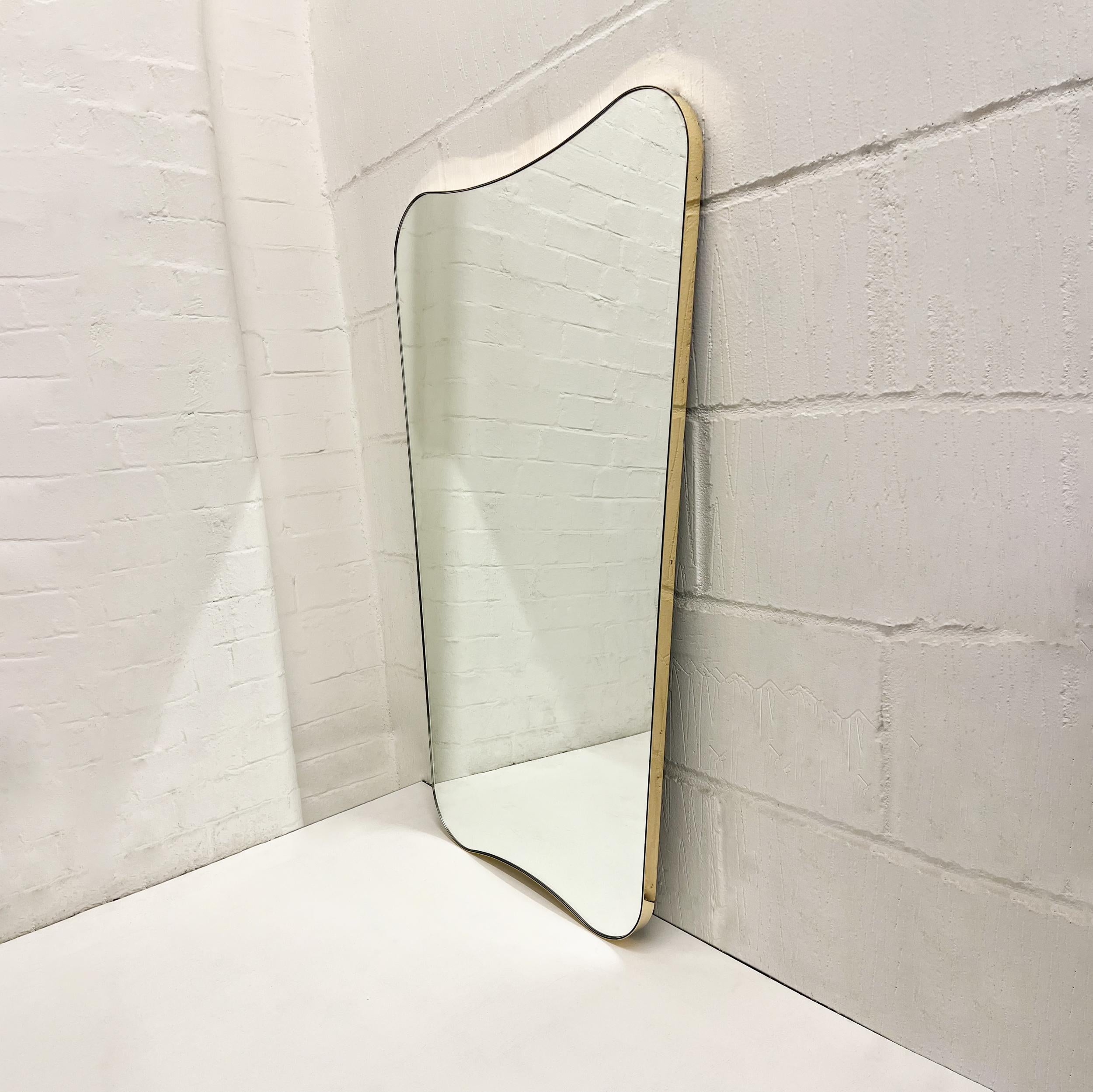 Elegant mid century style mirror with a minimalist brass frame inspired by the celebrated work of Italian designer Gio Ponti. Handcrafted in London, UK, to very high quality standards using pure solid brass.

Mirror dimensions: H 107cm x W 62cm x D