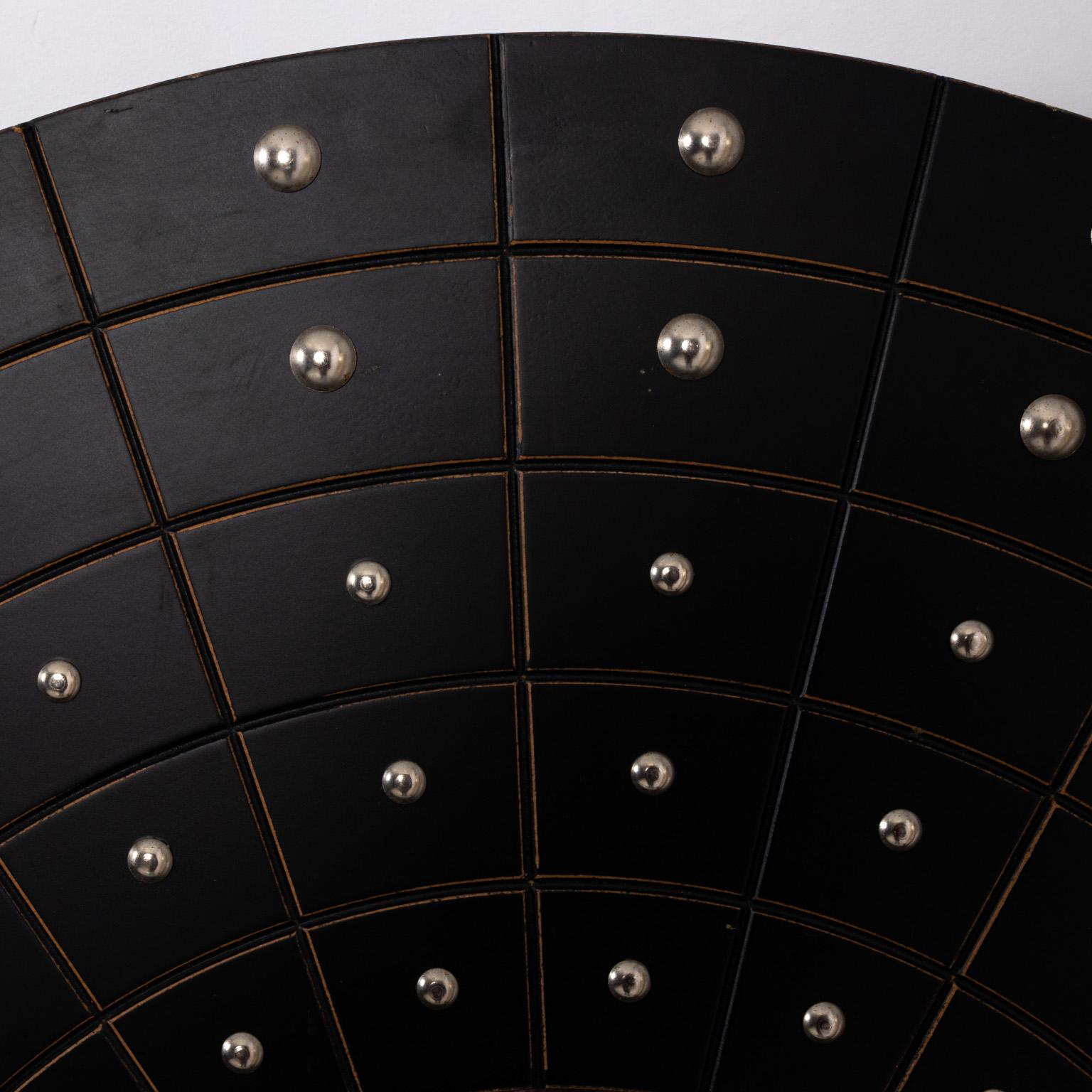 Round Art Deco style black painted wood frame mirror adorned with silver metal stud accents, circa 1970s. Please note of wear consistent with age including minor paint loss and scratches.