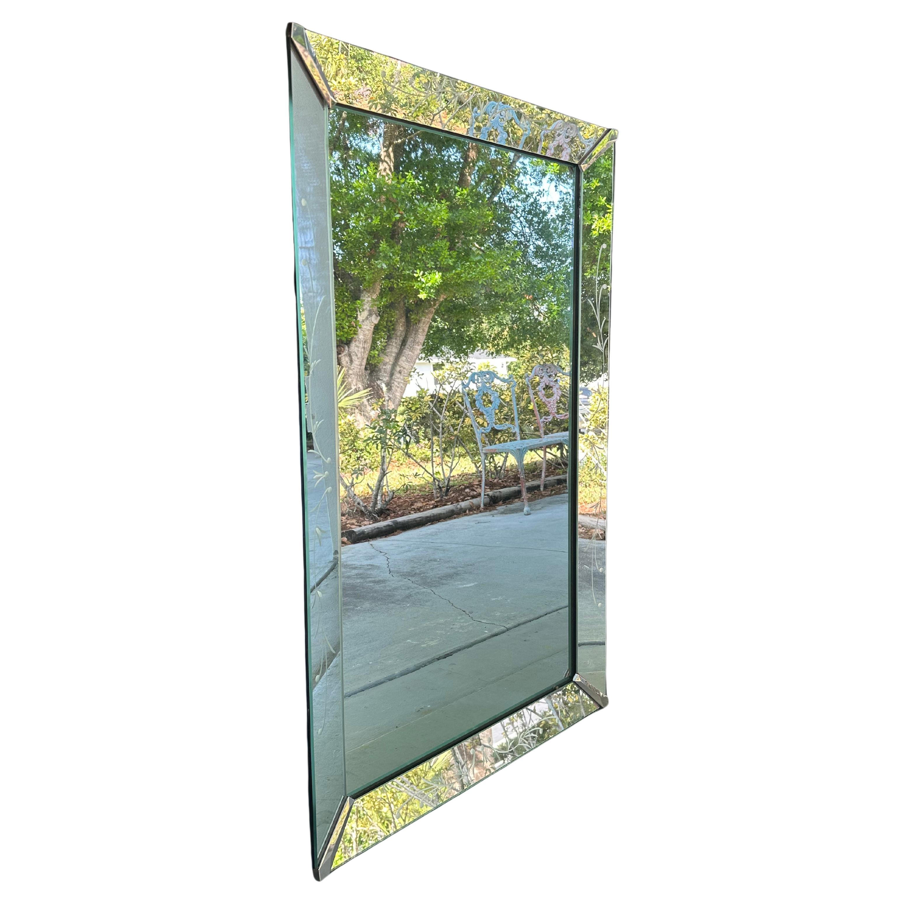 Mid-Century Art Deco Venetian Etched Wall Mirror.

Elegant rectangular vintage Venetian Art Deco wall mirror with stylized floral etchings. This mirror is meticulously handcrafted by skilled artisans. The etched floral motifs show exceptional