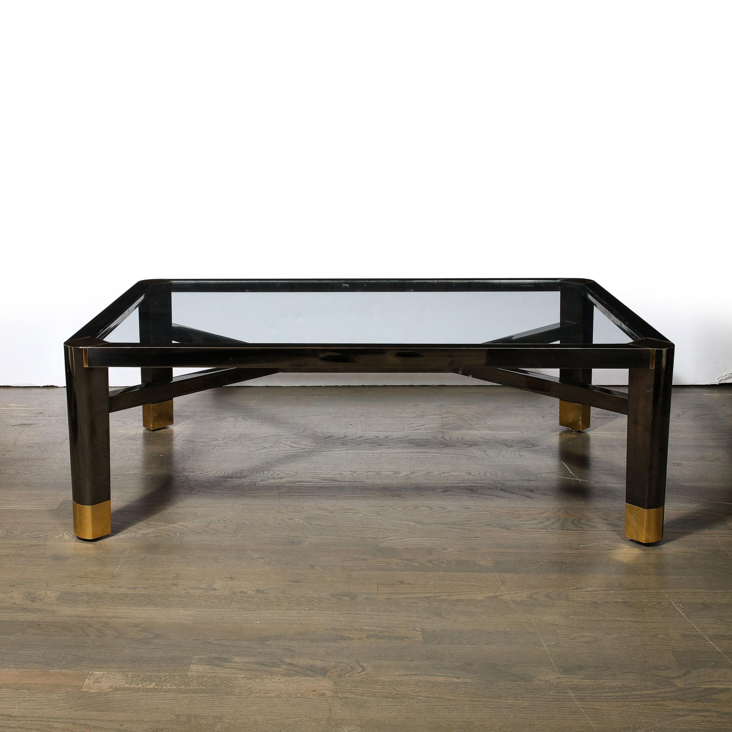 This bold and elegant Mid-Century Modernist Cocktail Table by Lorin Marsh originates from the United States, Circa 1980. Featuring a simplified geometric profile with precise material execution and detailing in Gunmetal and Polished Brass, the piece