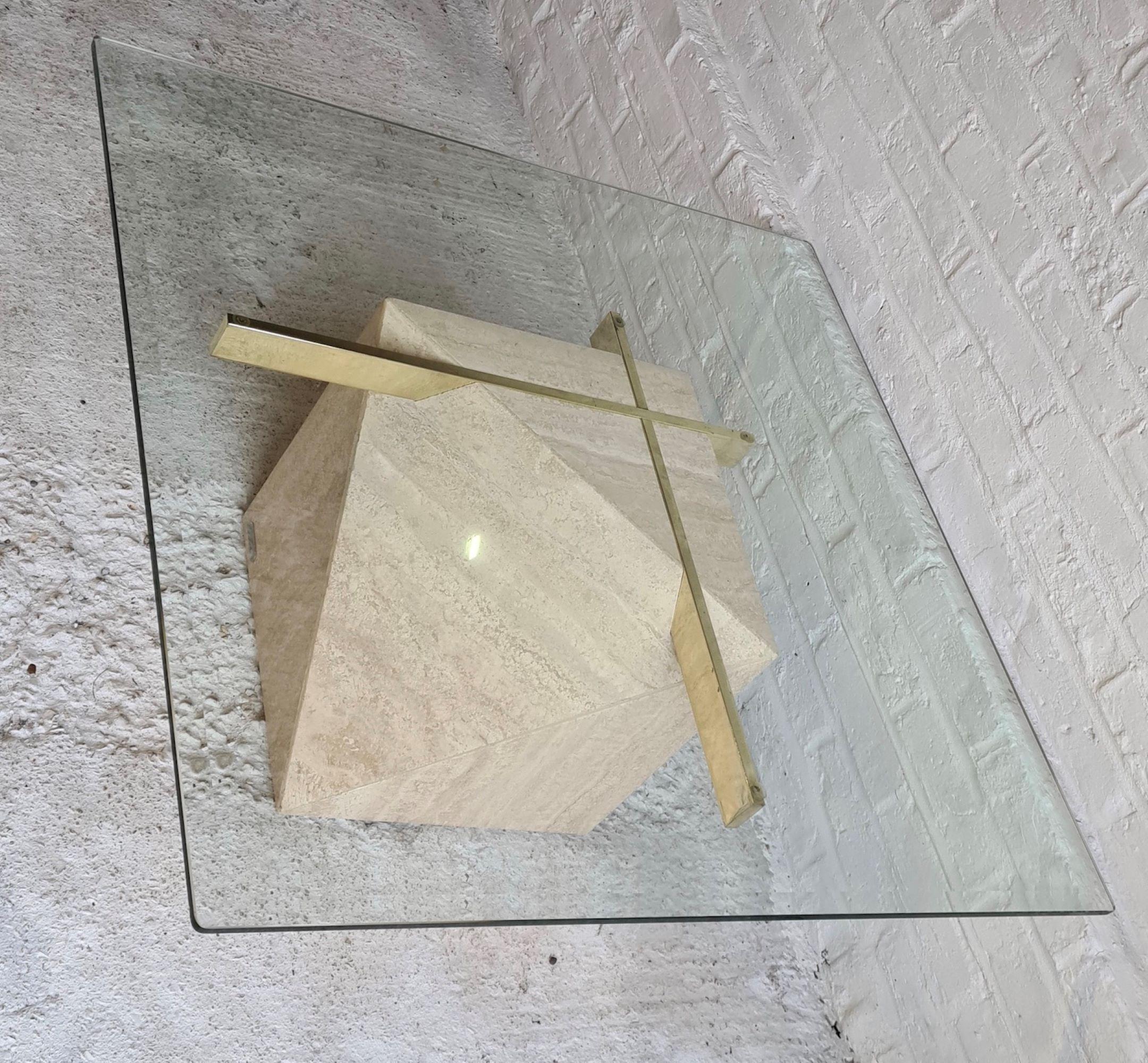 'Artedi' Travertine, brass and glass coffee, occasional table, 1970s

Very lovely travertine, brass and glass coffee table by ‘Artedi’. 
Trapezoidal shape travertine base, with brass cross supports. 

Heavy, square glass top.
