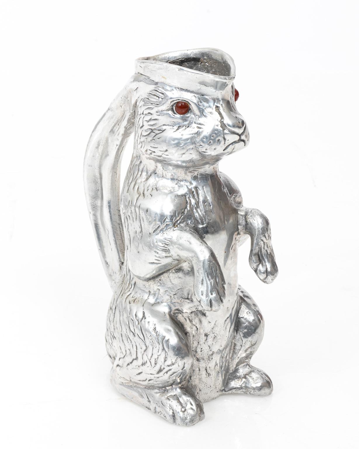 Arthur court pewter water pitcher in the shape of a bunny rabbit with gem stone eyes, circa 1975. Made in the United States. Please note of wear consistent with age.