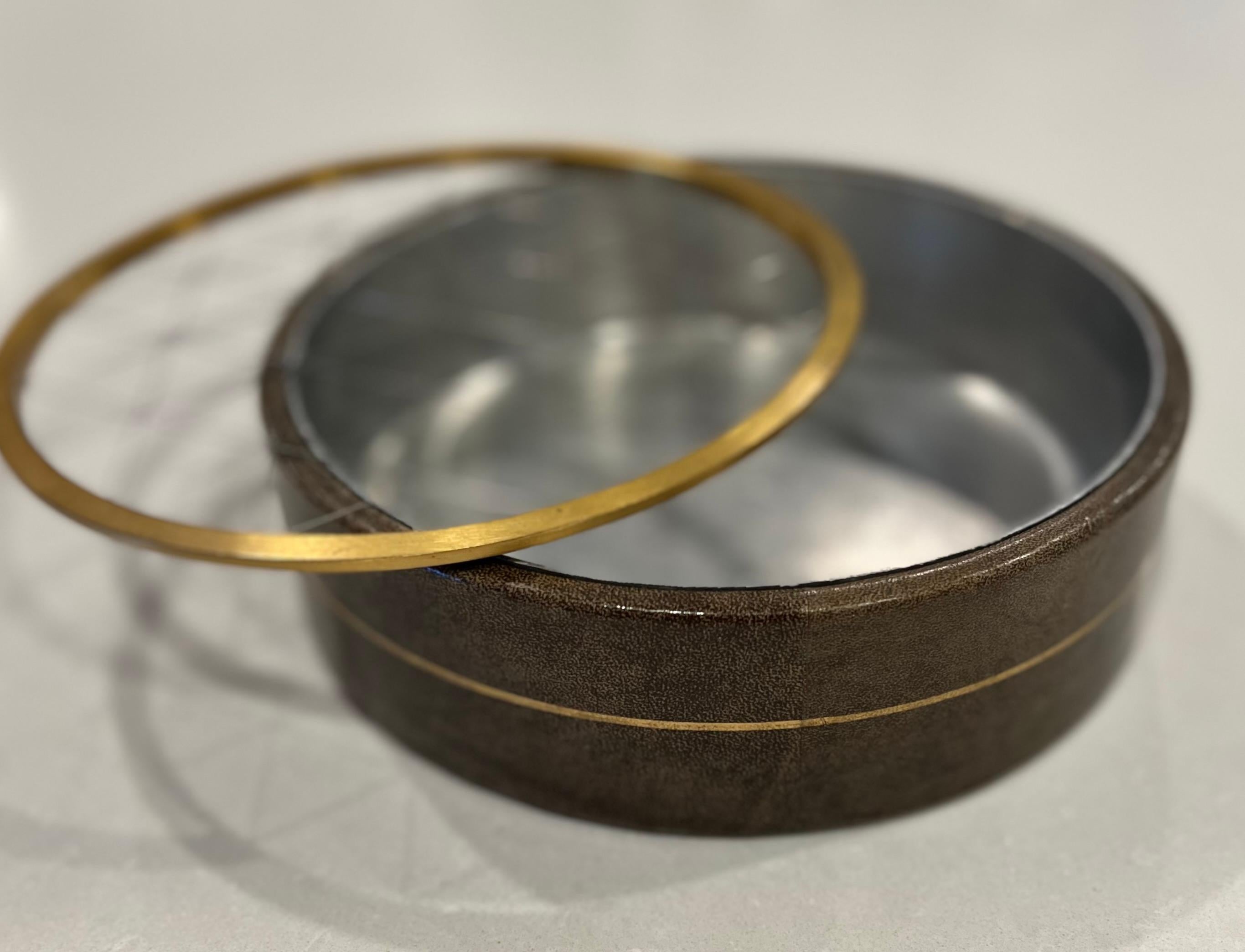 Charming Mid-Century Modern Arthur Hertzberg & Craftsmen leather and brass wire ashtray.   This ashtray dates back to 1950 and features a solid brass ring that holds stainless steel wire taut in an eye-catching criss-cross pattern at the rim,