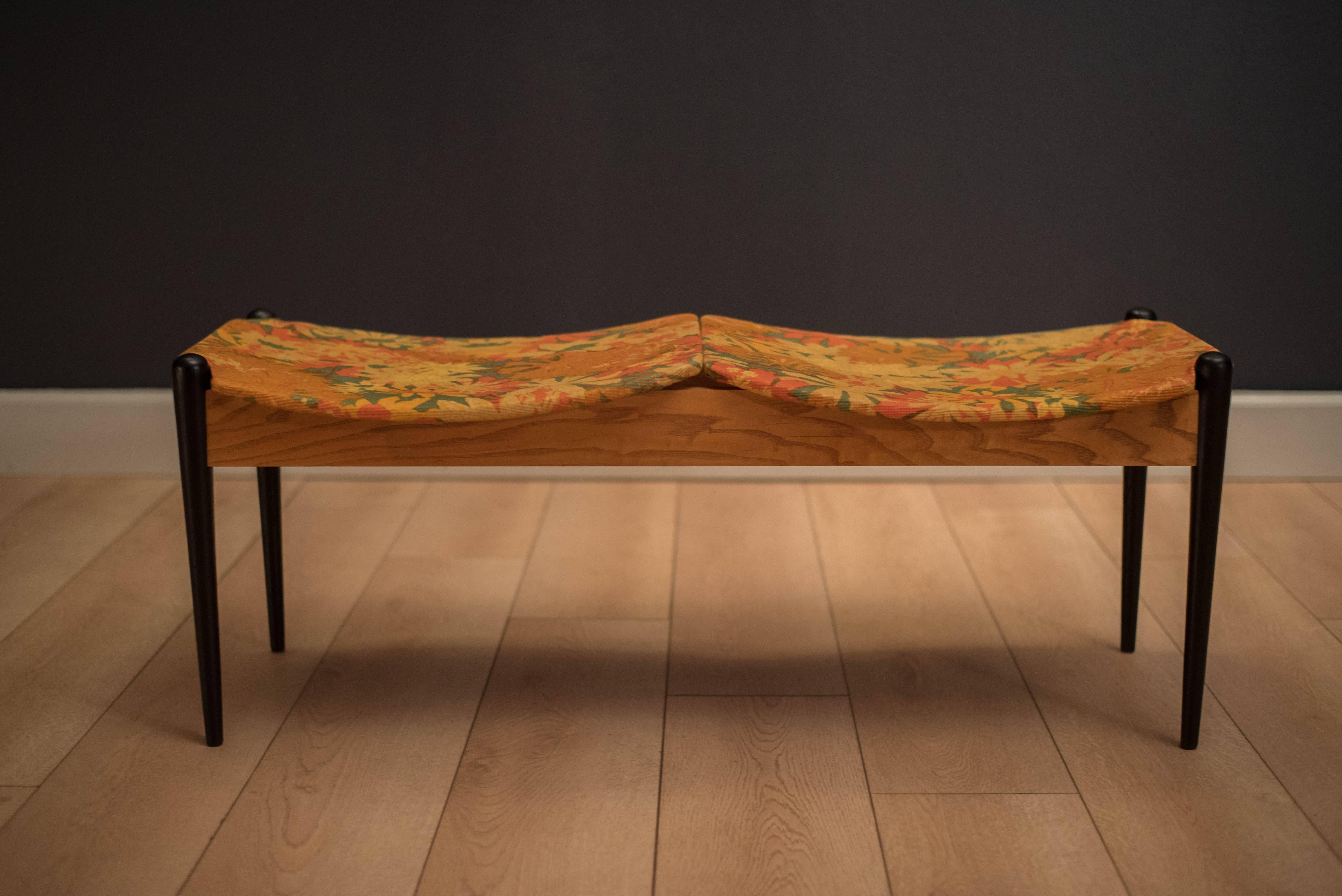 Classic Mid-Century Modern designed bench by Arthur Umanoff for Washington Wood Prod. Inc. This versatile piece features double seating with the original fabric and can function as an entryway or bedside bench.