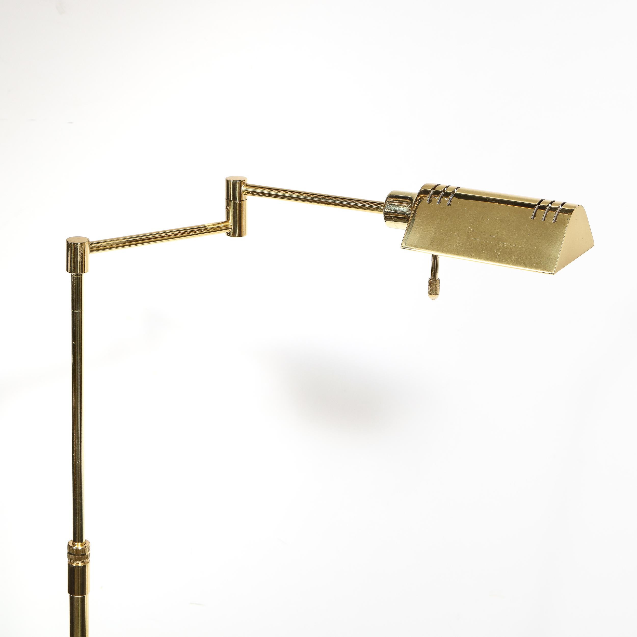 This elegant Mid-Century Modern articulating floor lamp was realized in the United States, circa 1970. It features a circular base from which a tubular body ascends upwards connecting to two adjoined articulating arms at a right angle. The