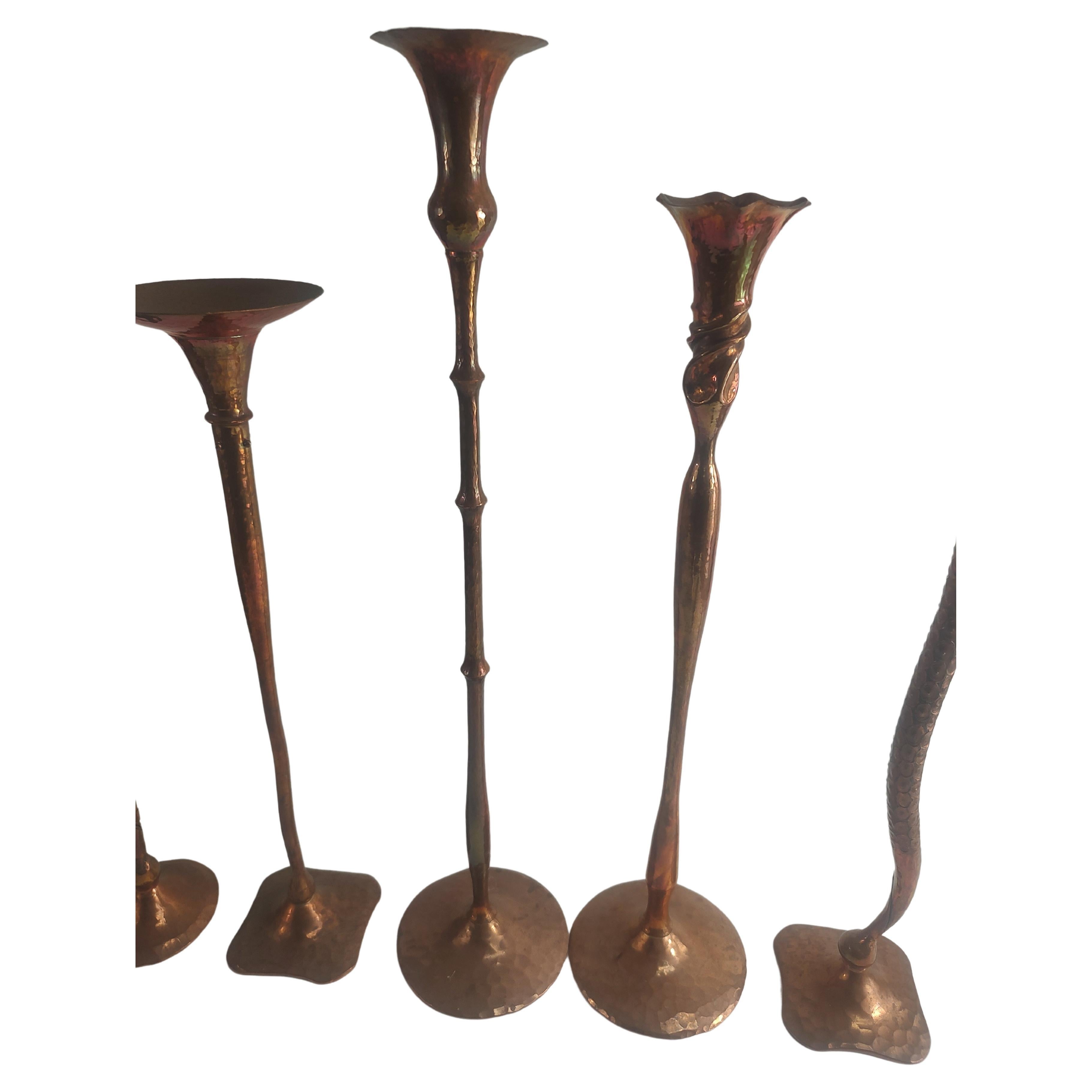 Simple and elegant hand hammered copper candle holders by Hessel Studios of San Rafael California. All signed on base and totally handmade. In this group of five the tallest is 18.75 x 4 diameter and the shortest is 15 x 3. When selecting please