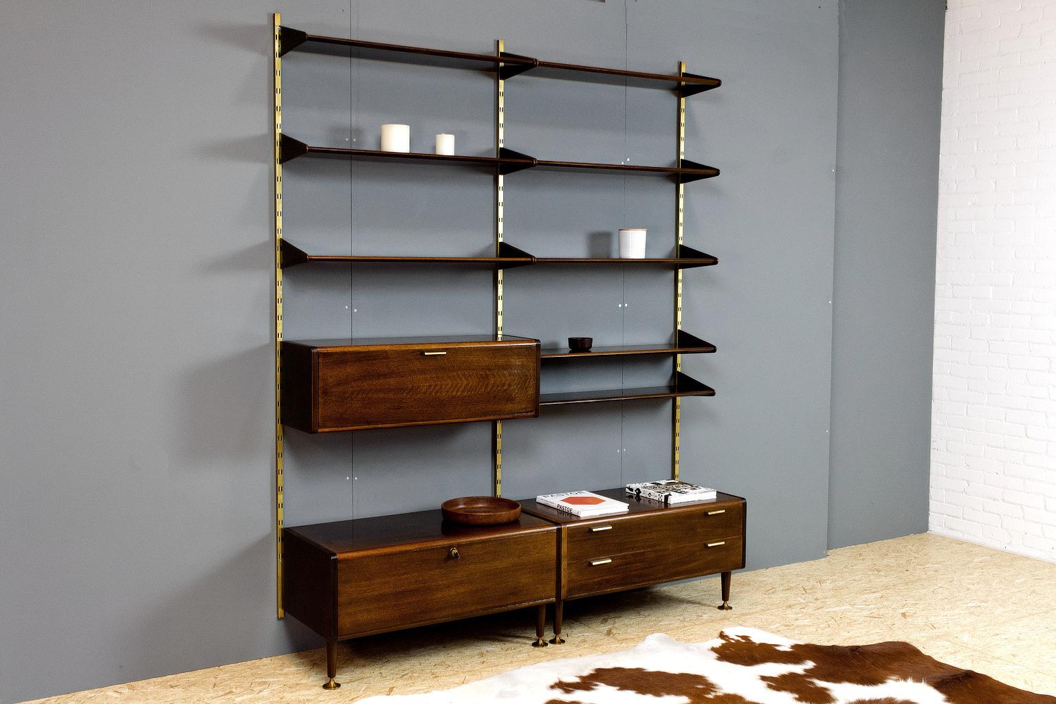 Original modular wall unit executed in polished ash with brass details and uprights, designed by Abraham Patijn during the early 1950s. The trumpet feet, and the rounded shelves and cabinets, show the great craftsmanship of Dutch Mid-Century Modern