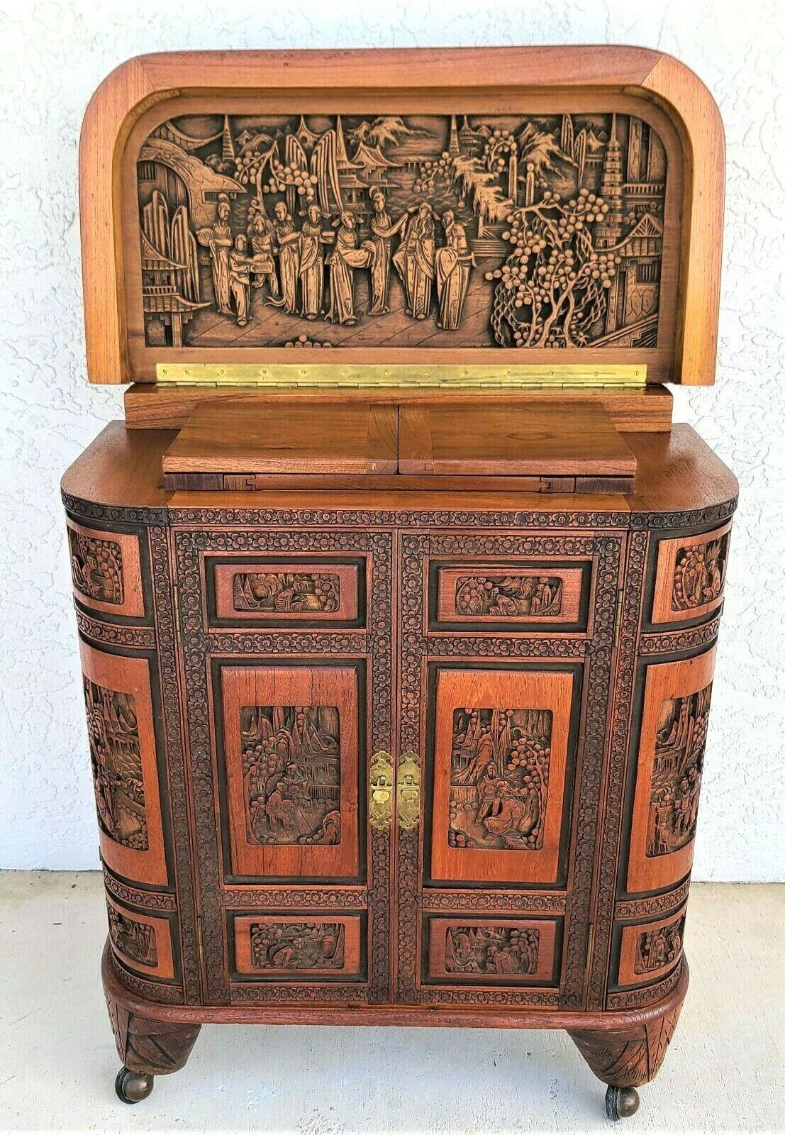Offering One Of Our Recent Palm Beach Estate Fine Furniture Acquisitions Of A
Mid-Century Asian Oriental Hand-Carved Camphor Wood Dry Bar Cabinet Flip Top
Wonderfully detailed piece with many compartments.

Approximate measurements in inches
35