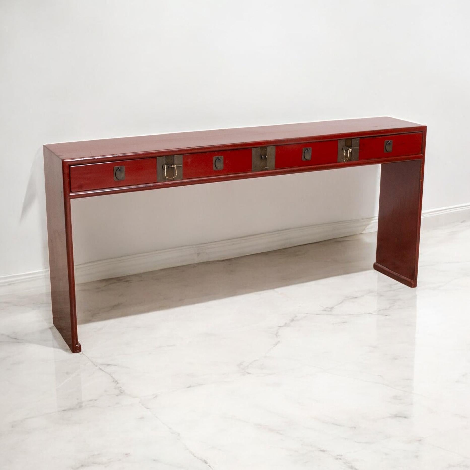 This is a mid-century Chinese console table with a red lacquer finish. It has four drawers with a Chinese brass pin locking system. The size is excellent. 