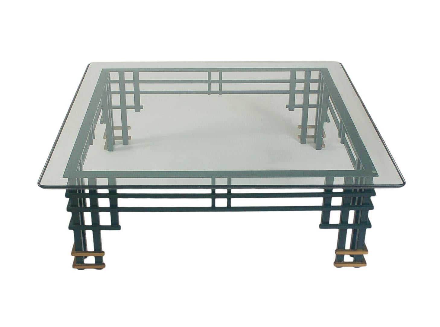 A large and impressive coffee table with an Asian modern contemporary look. It features emerald green coated steel, brass accents, thick clear glass top. Very clean ready to use condition.